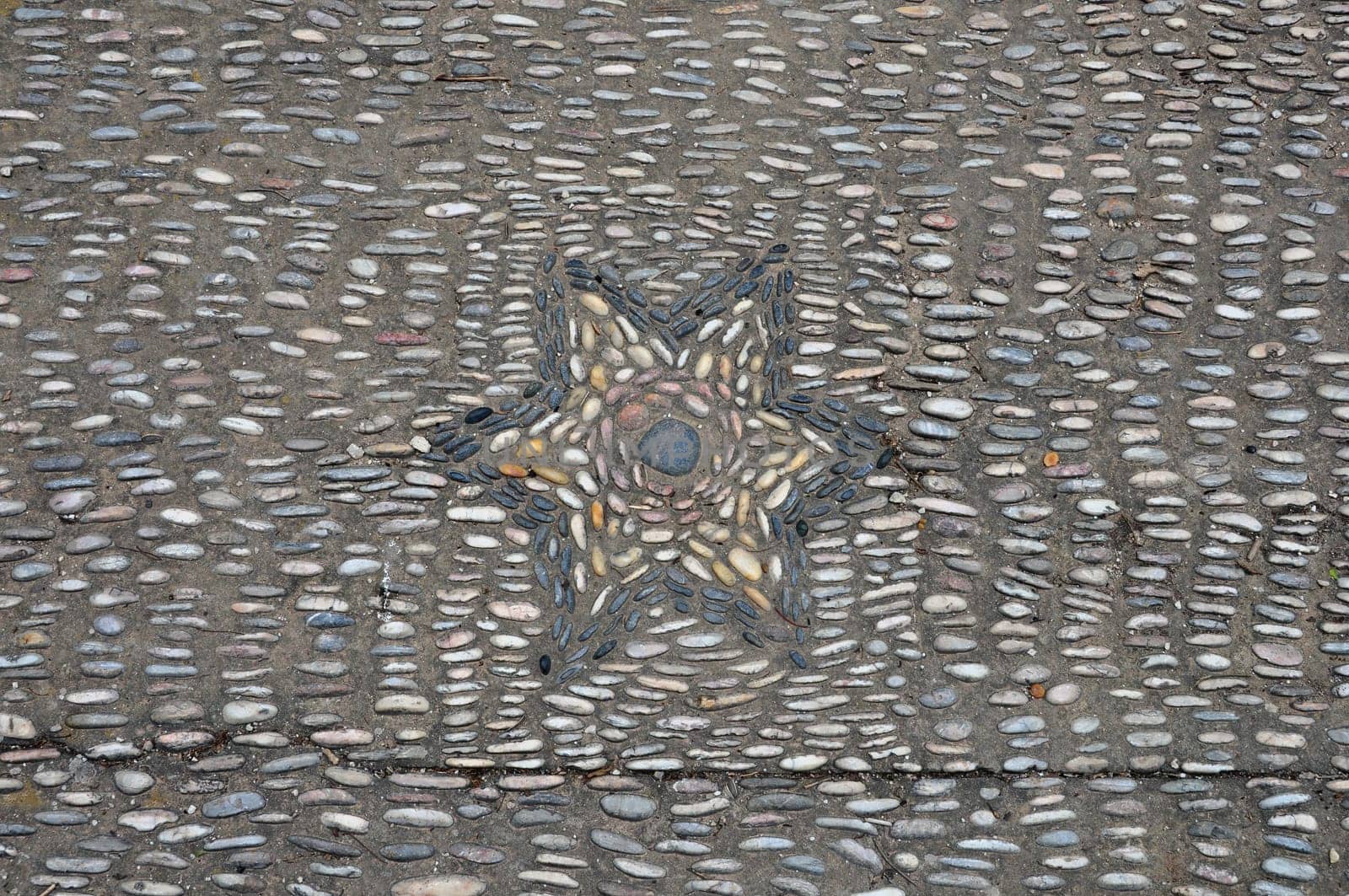 Pebble mosaic with star pattern abstract background.