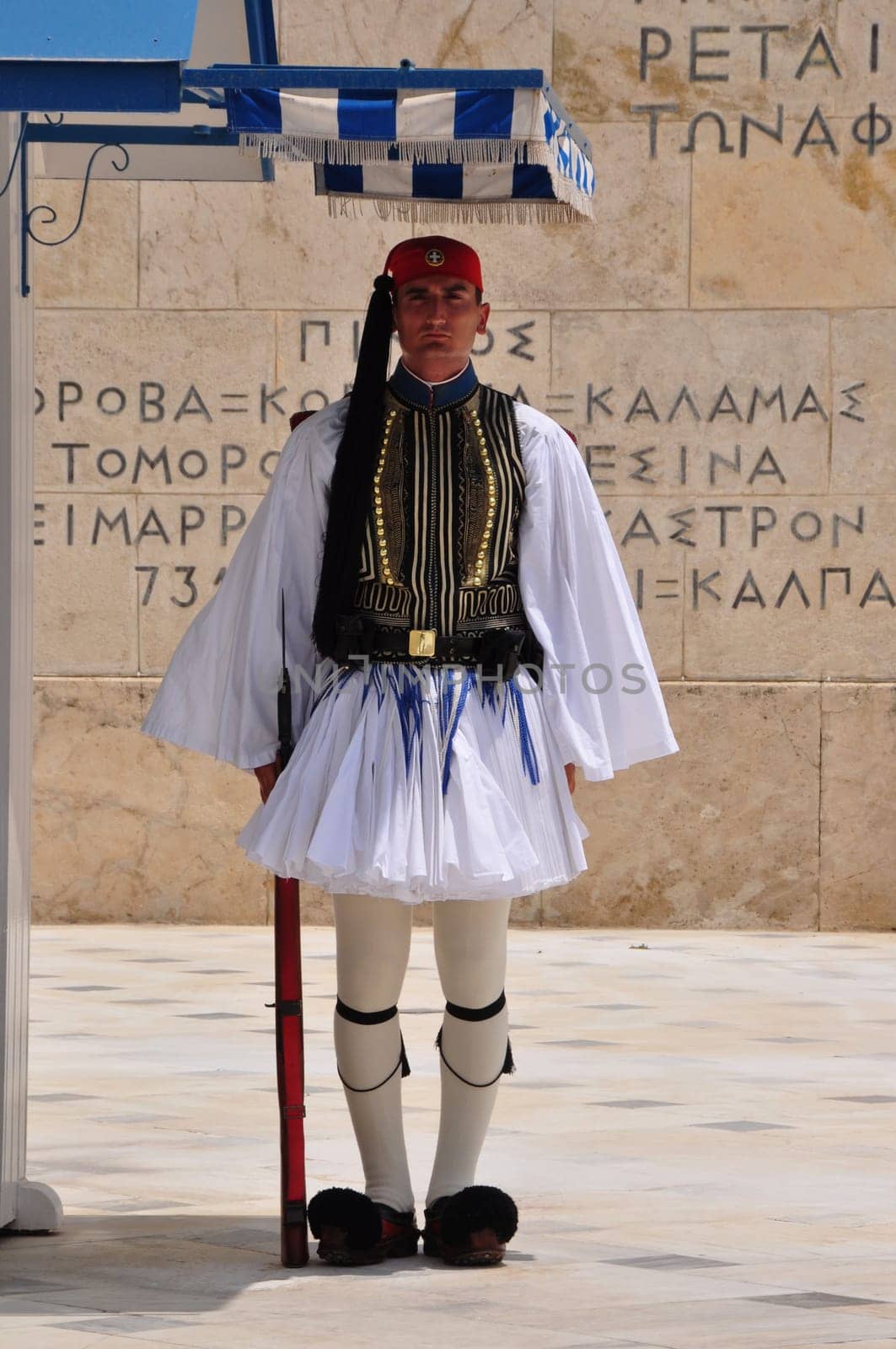 ATHENS, GREECE - JUNE 9, 2014: Evzone soldier with traditional uniform standing guard at the Tomb of the Unknown Soldier in Athens, Greece.