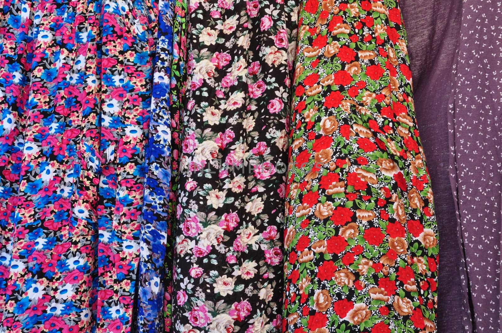 Old fashioned garments with floral pattern abstract textile colorful fabric background texture.