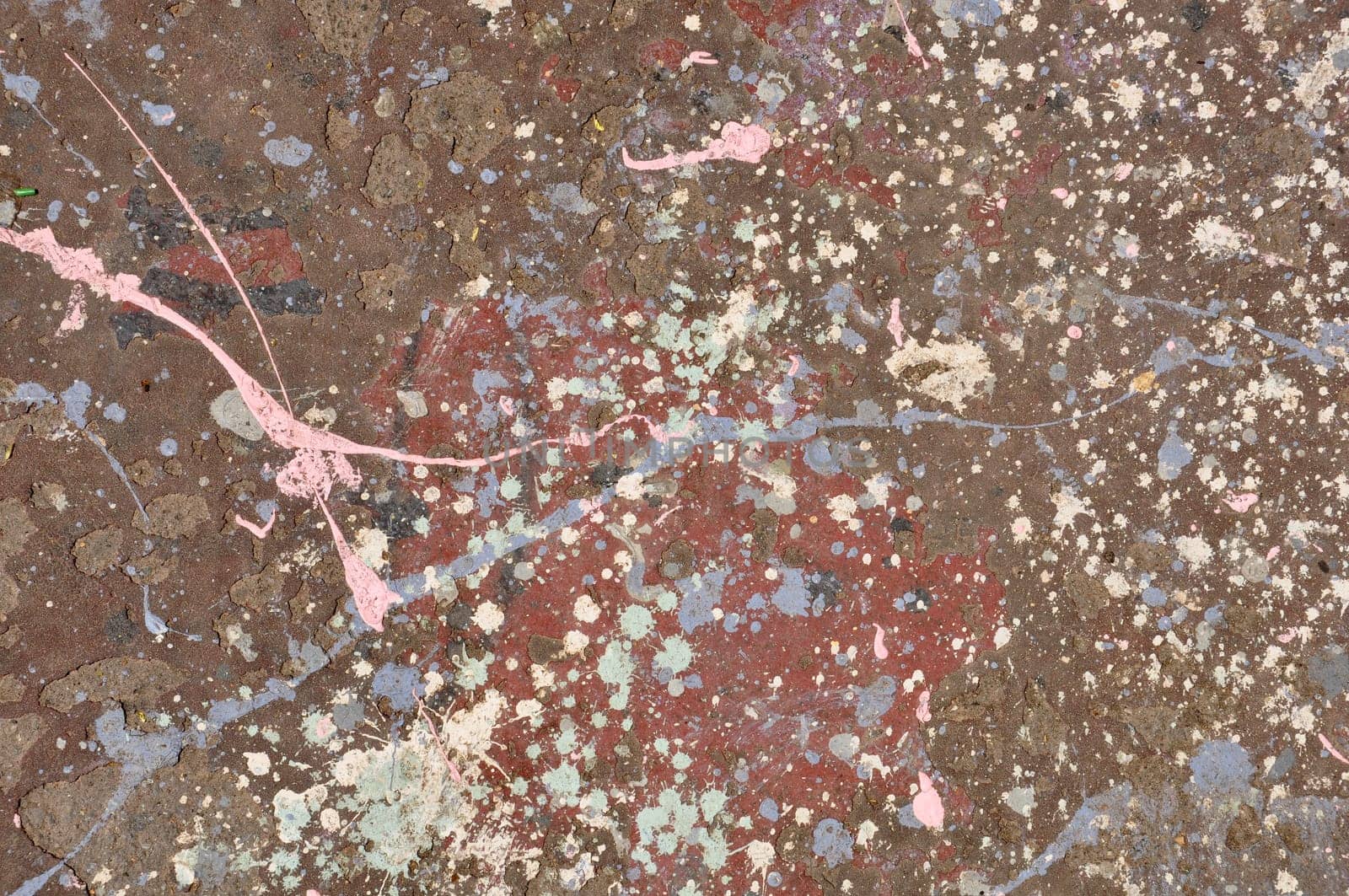 Colorful paint drips on peeling wall abstract artistic background texture.