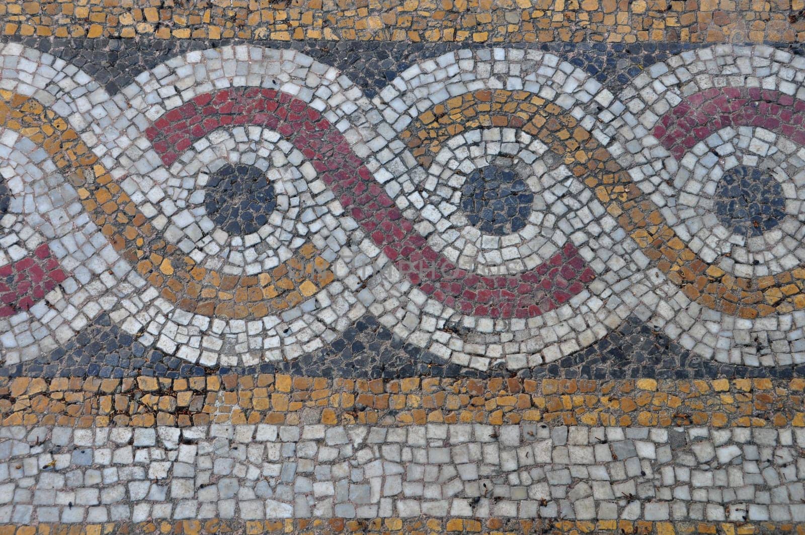 Floor mosaic background with circles pattern abstract geometric design on byzantine era church exterior.