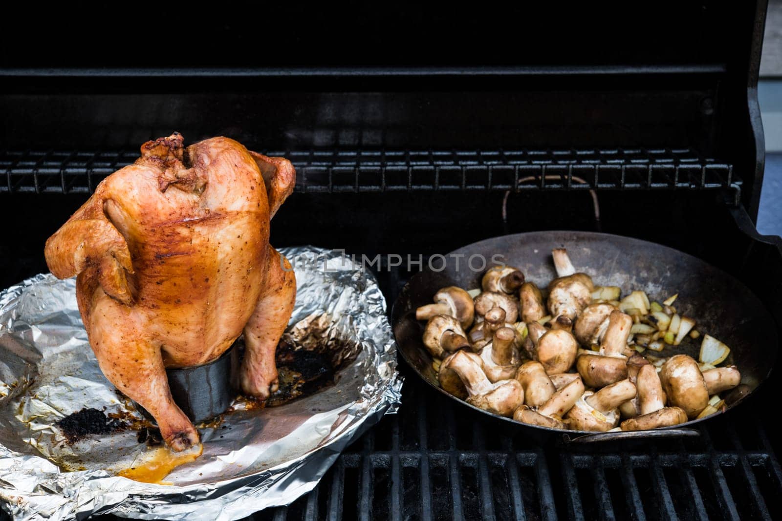 crunchy grilled completely chicken sitting on  barbecue