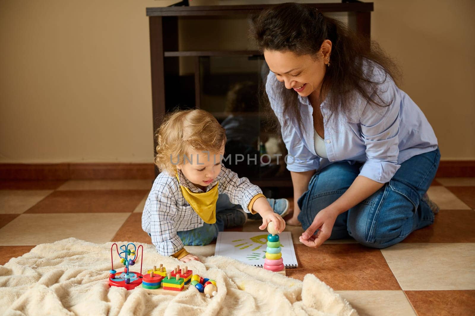 A joyful moment of a mother with her child engaging in playful activities, fostering learning and bonding in a nurturing home environment.