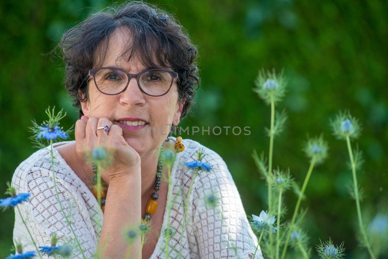 a portrait of a beautiful senior woman in the garden