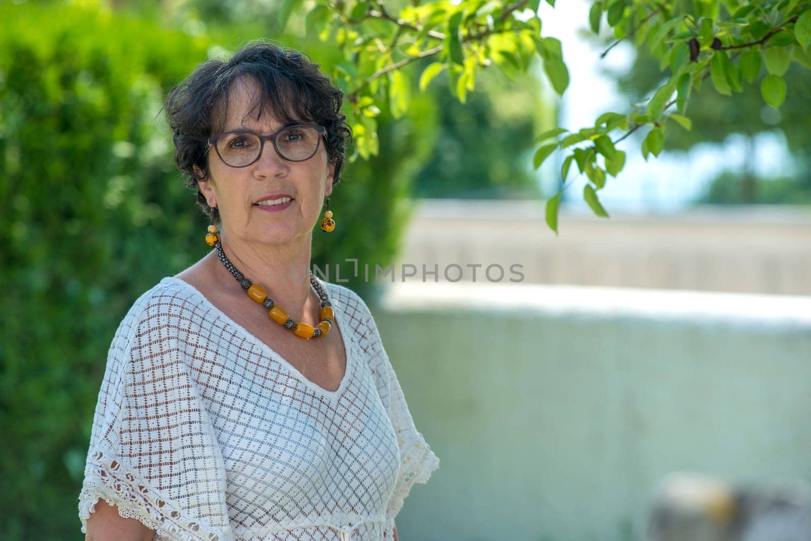 a portrait of a beautiful senior woman in the garden