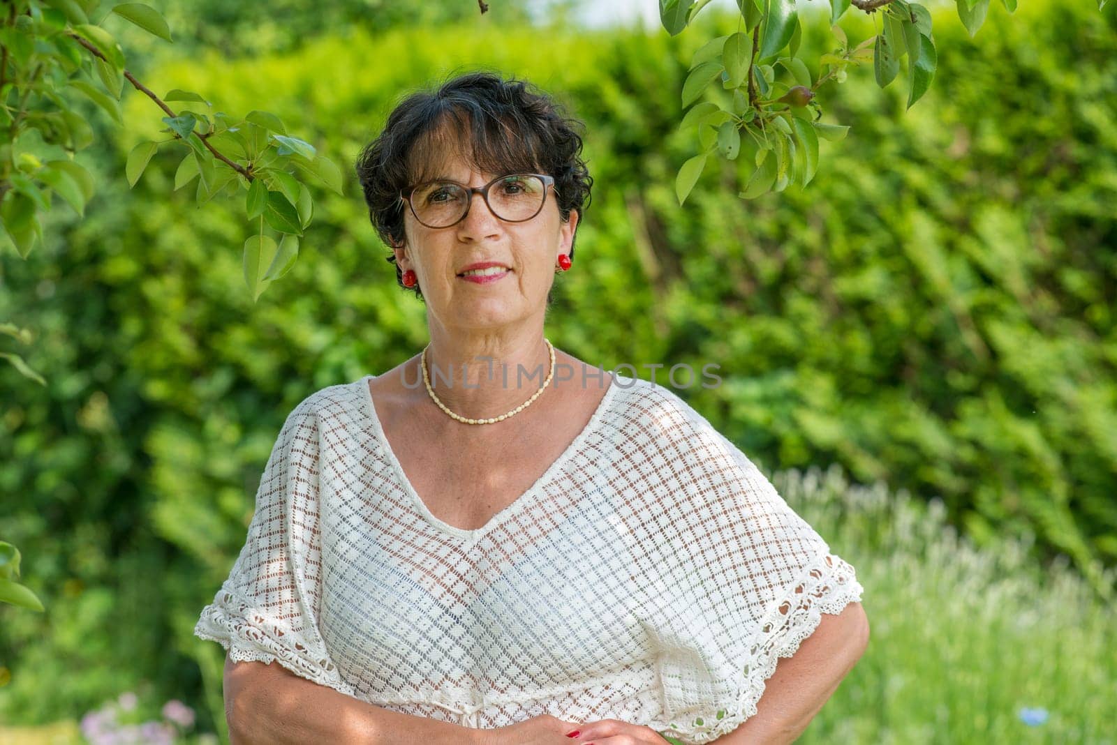 a portrait of a beautiful senior woman in the garden