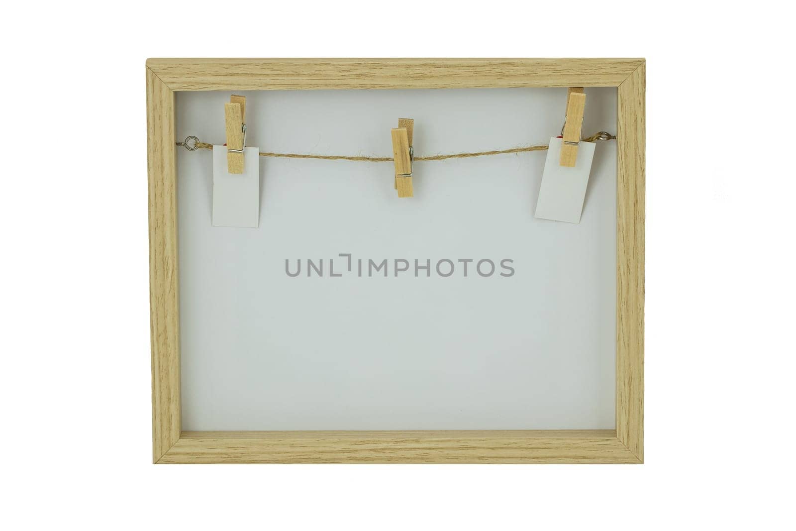 Empty wooden frame with a clothesline and clothespins on the background of frame. Isolated on white background.