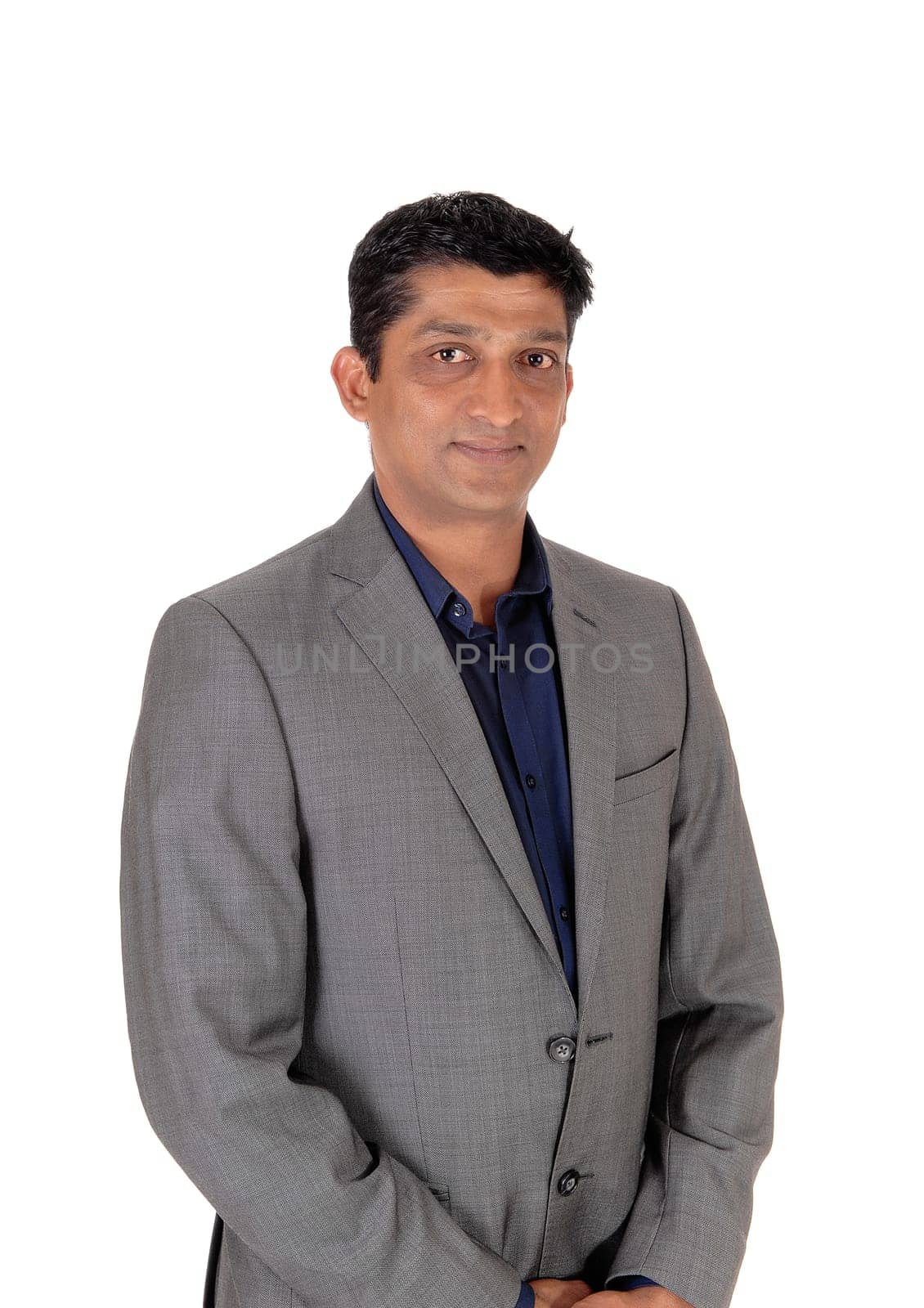 A waist up image of a handsome business man in a gray suit and blue.shirt standing isolated for white background.