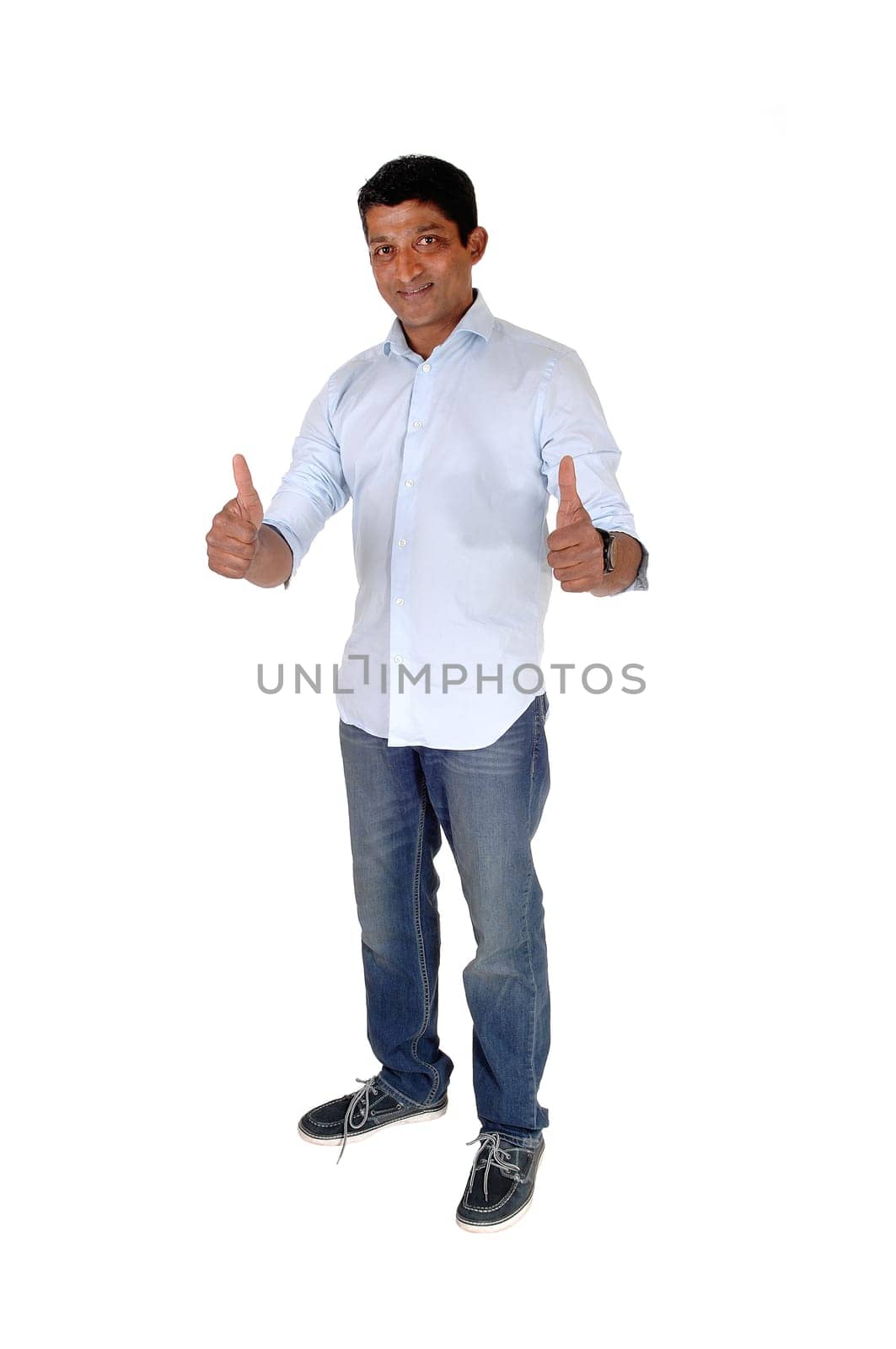 A full body image on an East Indian man in jeans and blue shirt standing.with booths of his thumps up, isolated for white background.