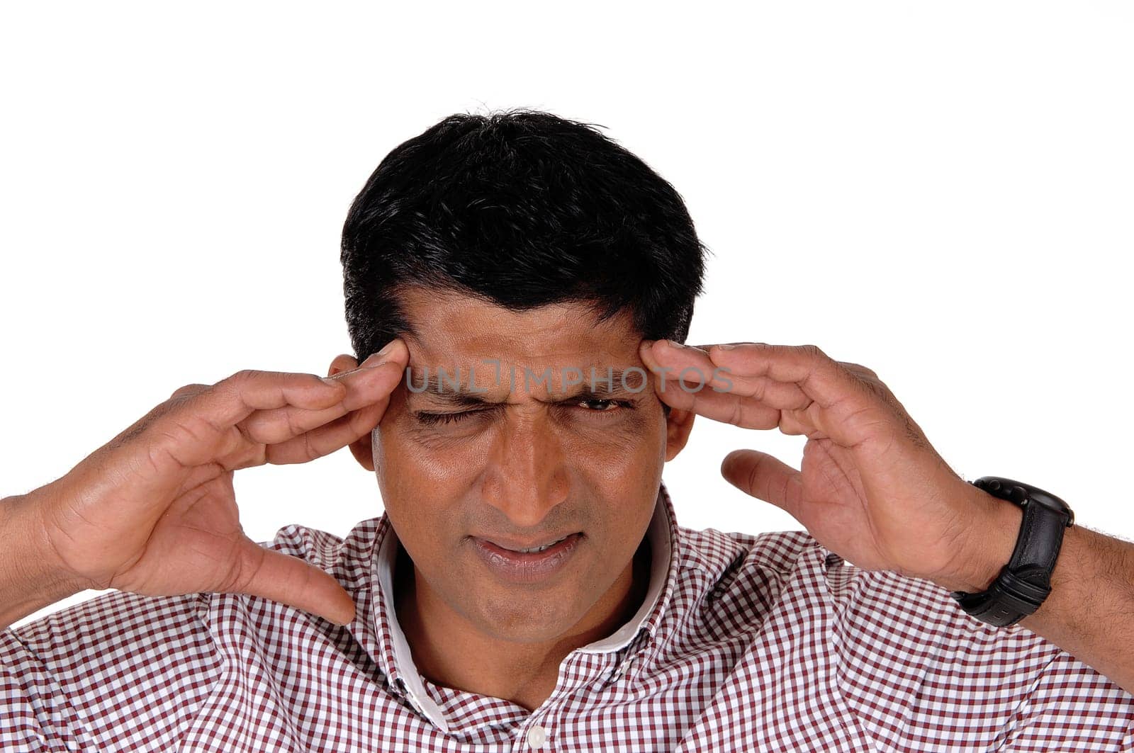 A closeup image of an East Indian man with very heavy headache.closing his eyes and rubbing his head, isolated for white background.