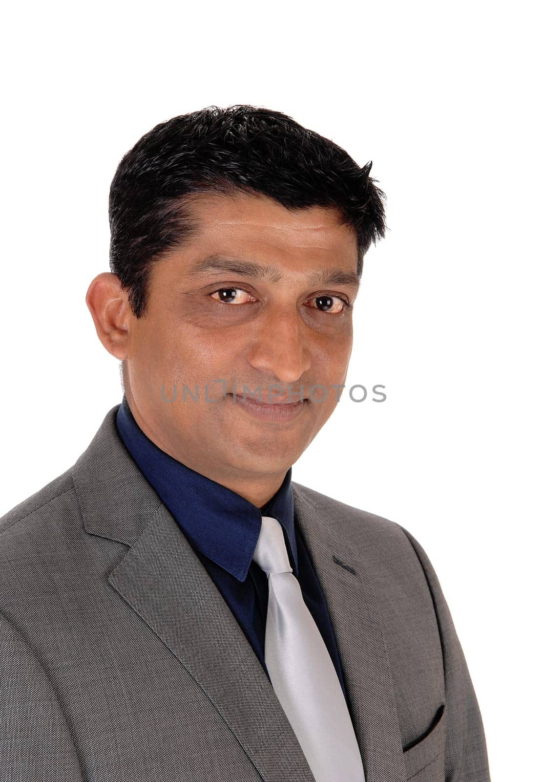 A handsome east Indian businessman in a gray suit and black hair.looking into the camera, isolated for white background.