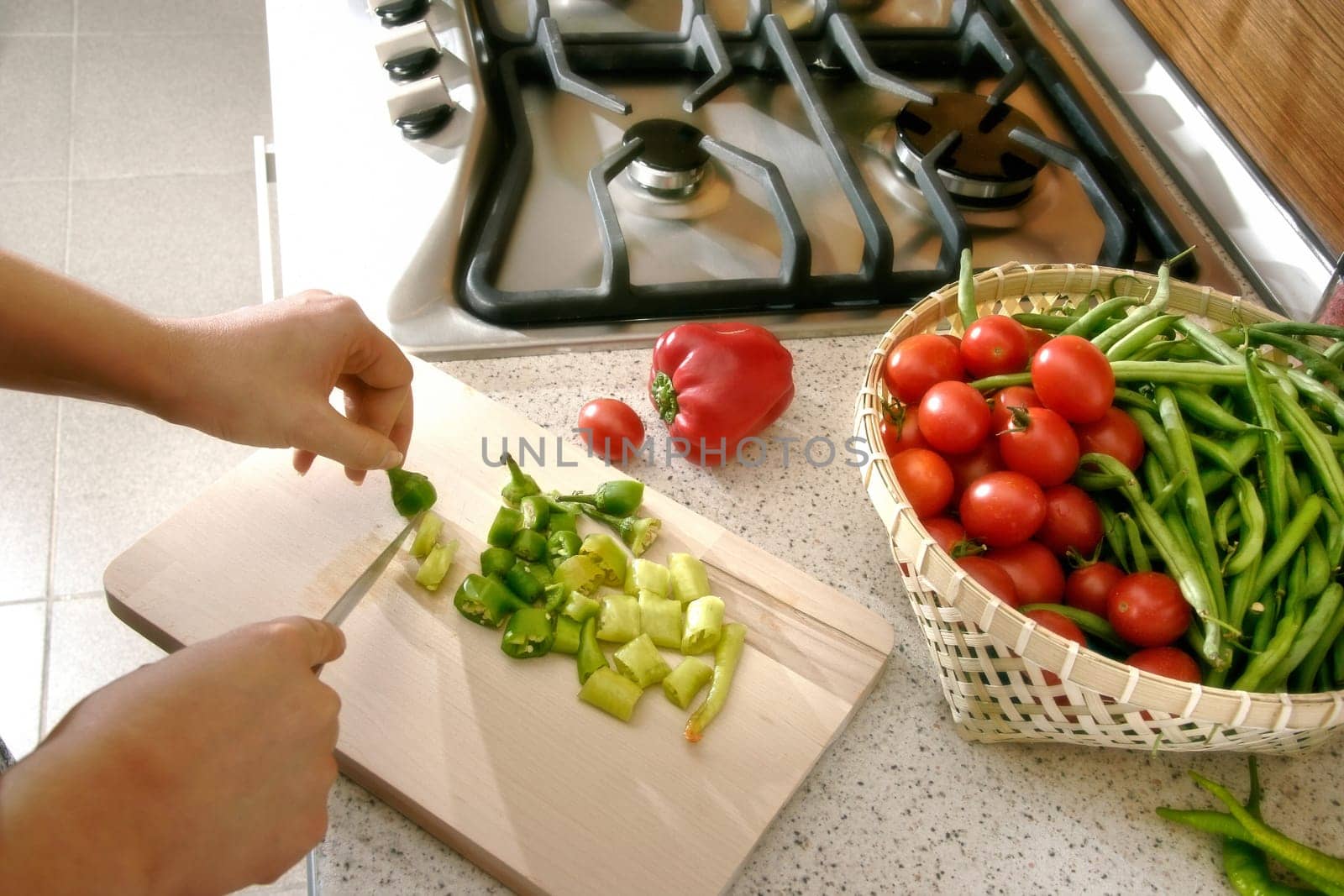 woman cutting vegetables in domestic kitchen