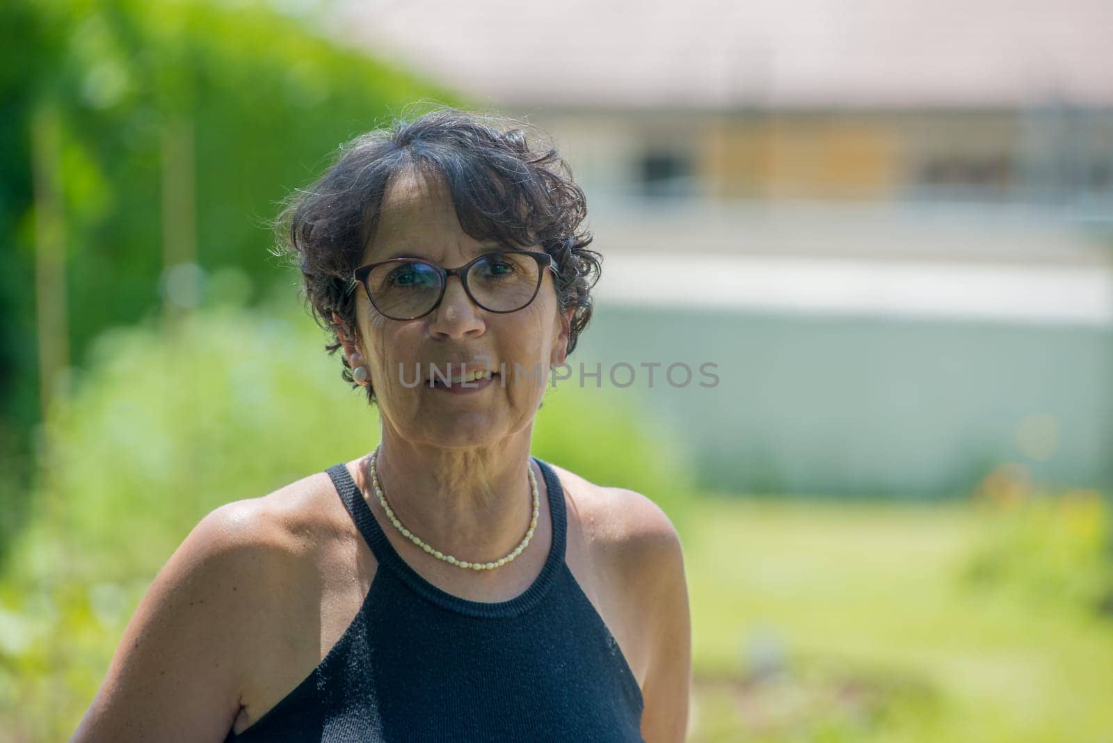 a portrait of a beautiful senior woman in the garden