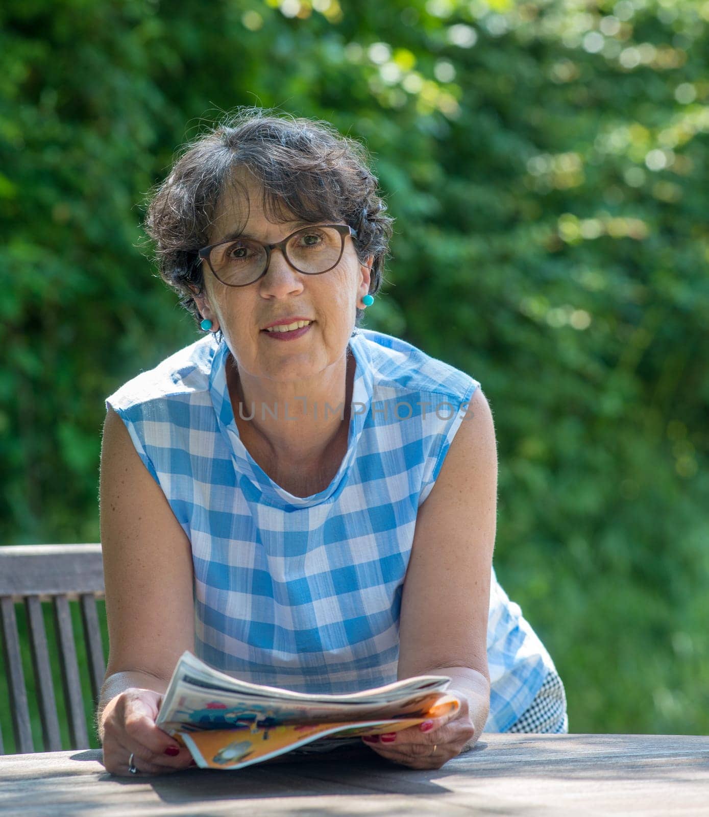 a portrait of a beautiful senior woman in the garden