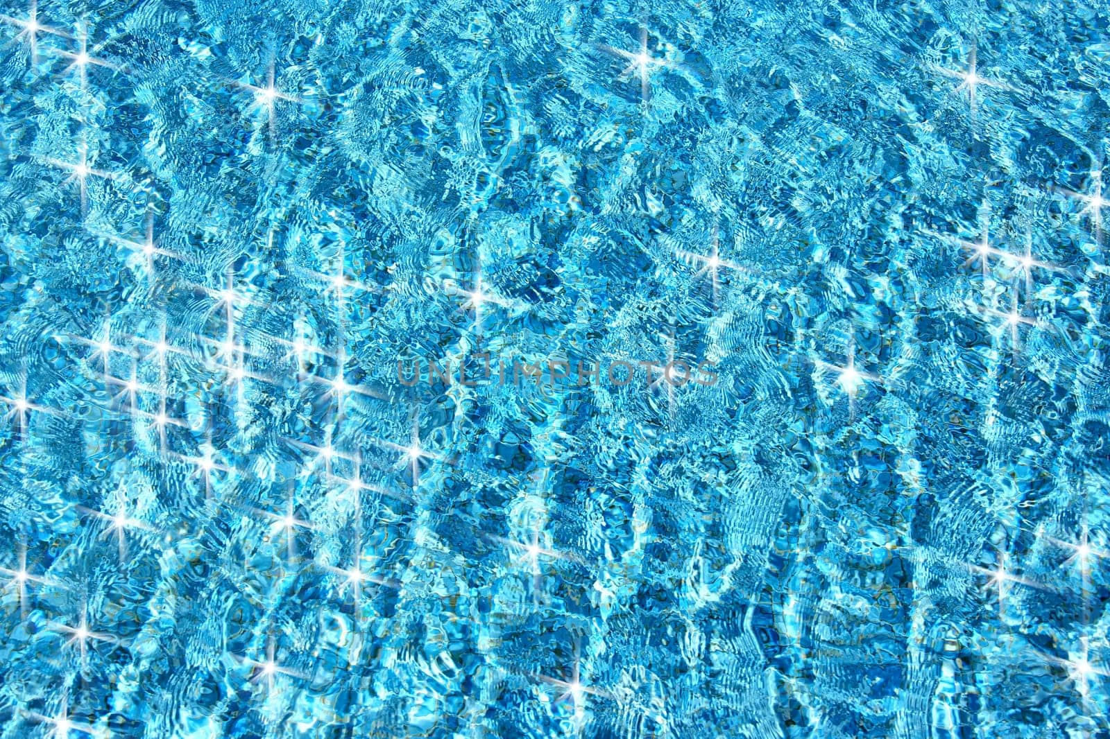 close up shot of clear blue pool water and light.