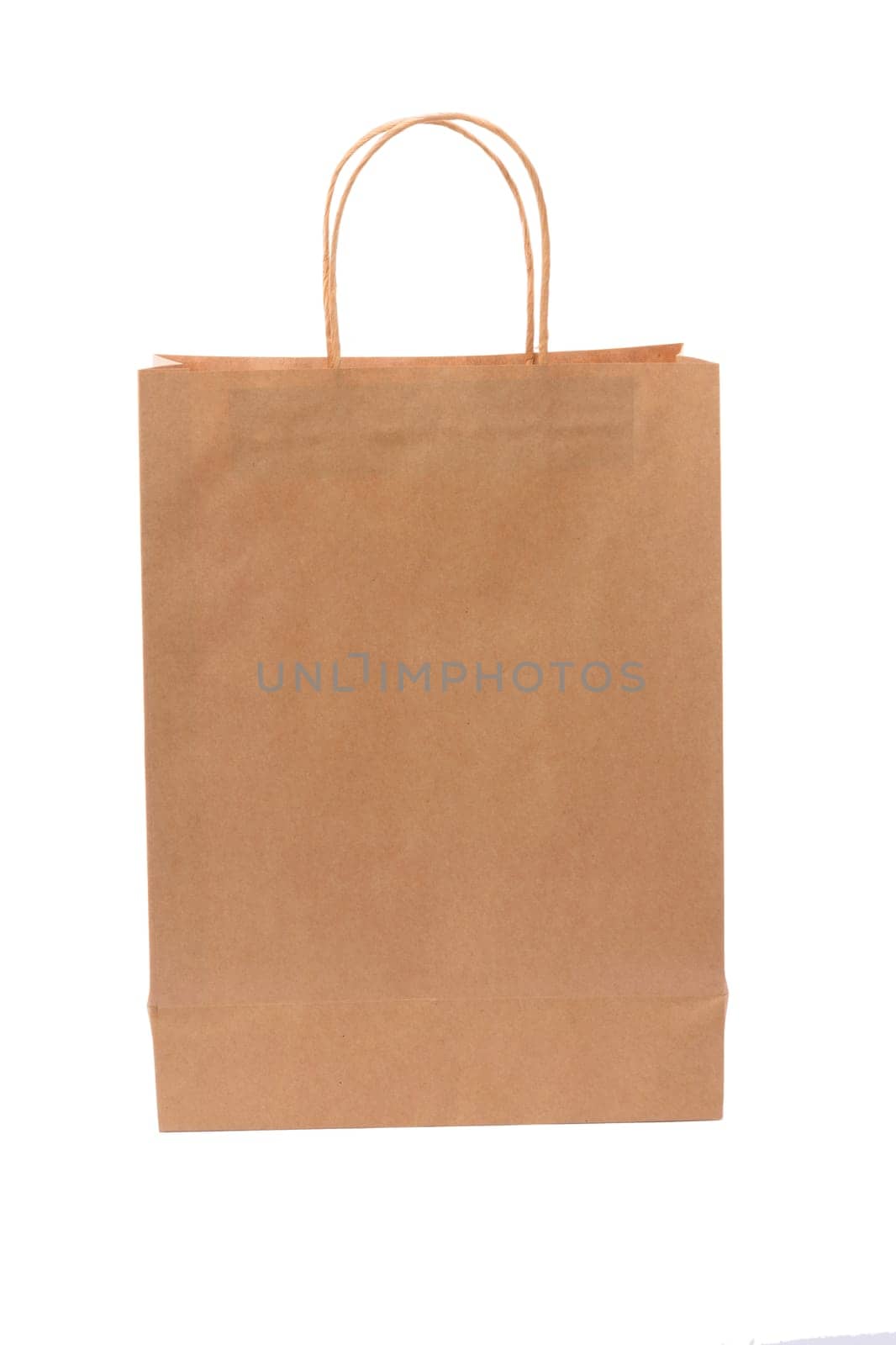 Brown paper shopping bag on white background. Empty area.