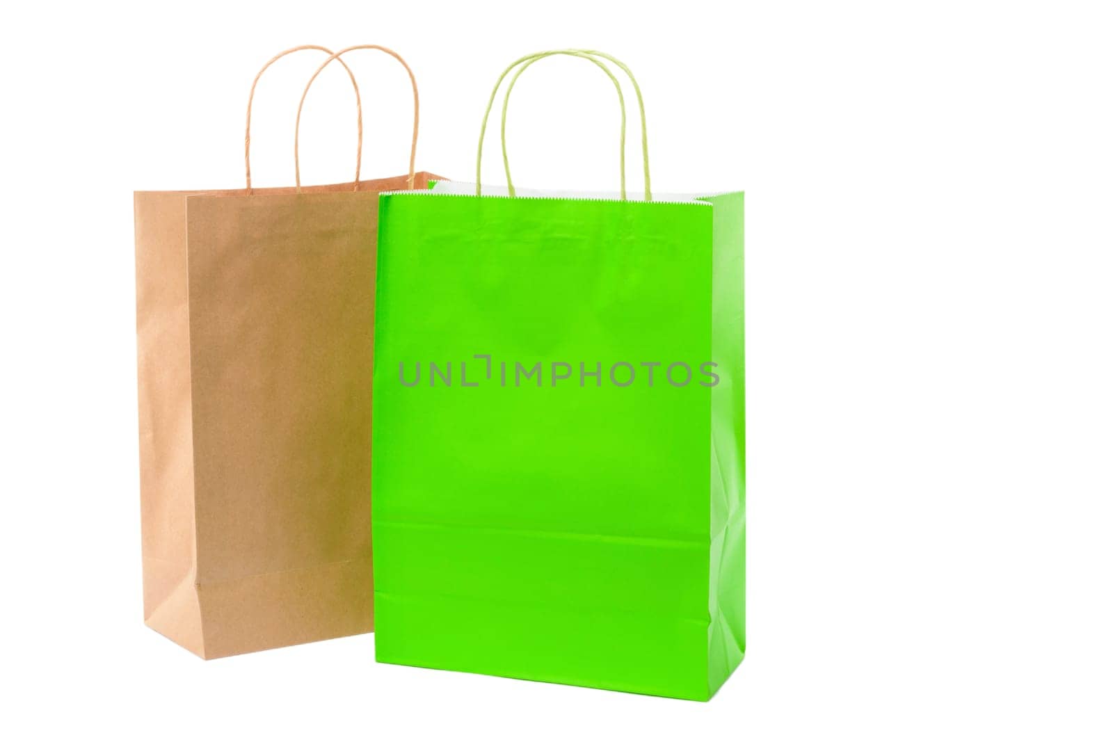 Variety of colored paper shopping bags on white background. Empty area.