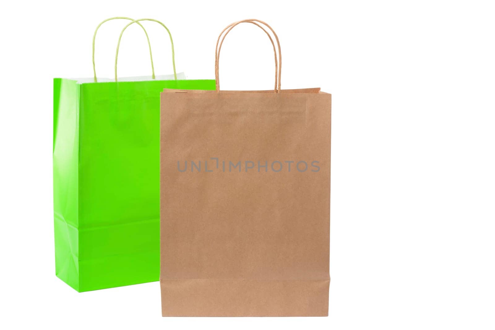 Variety of colored paper shopping bags on white background. Empty area.
