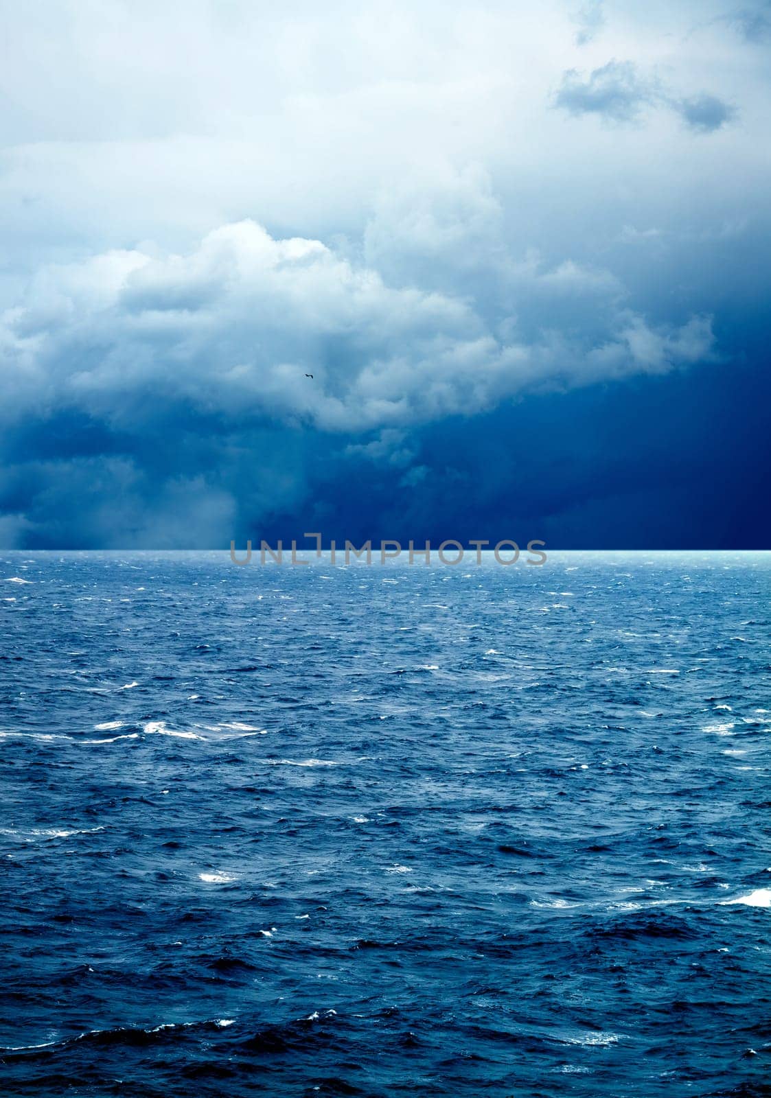 seascape image of windy weather and waves on sea over cloudy sky