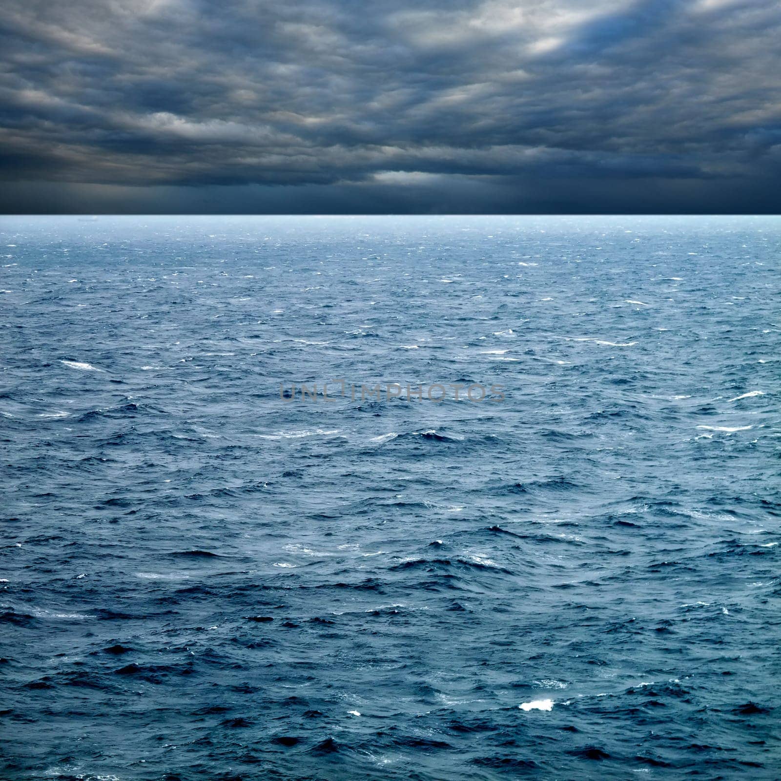 seascape image of windy weather and waves on sea over cloudy sky