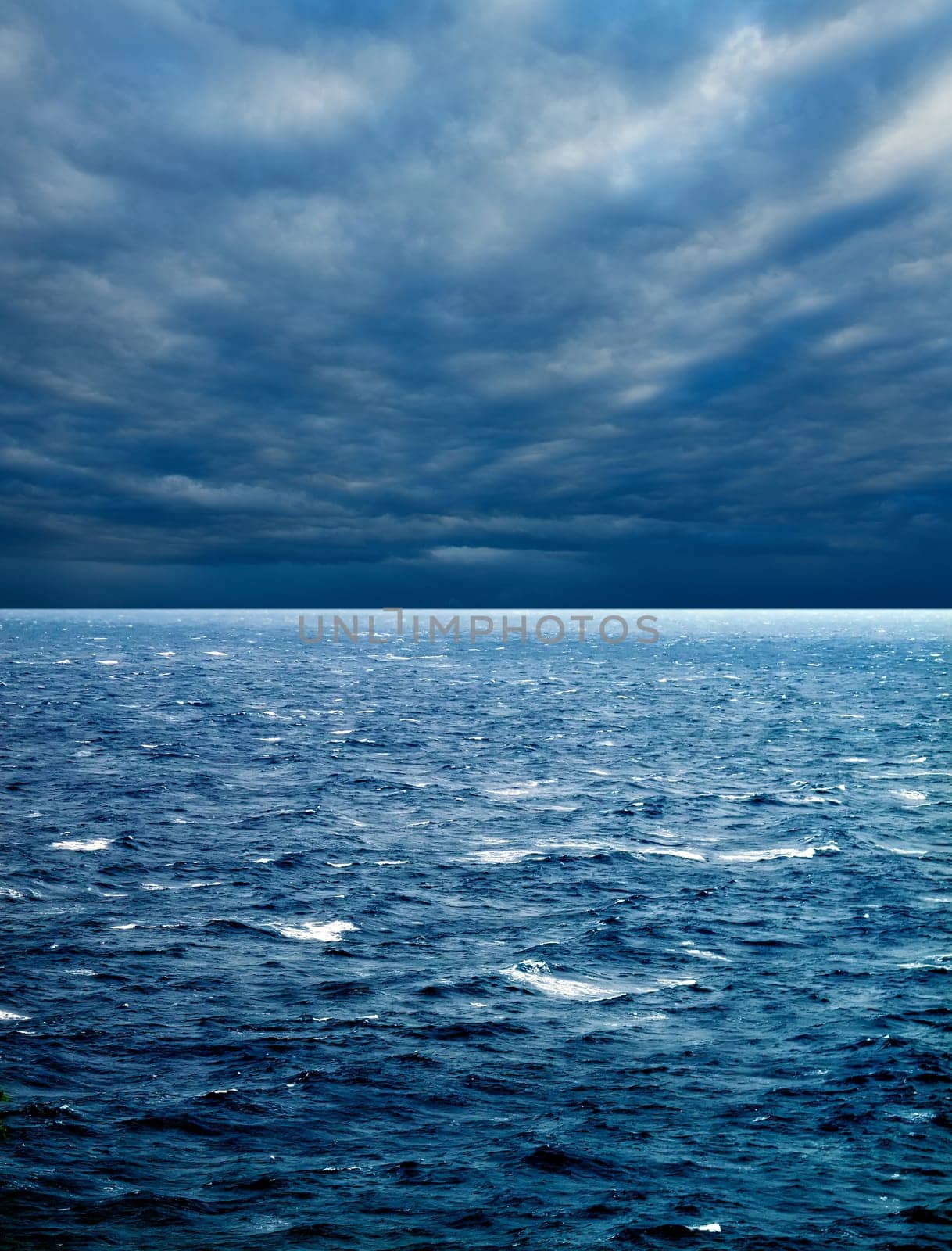 seascape image of windy weather and waves on sea over cloudy sky