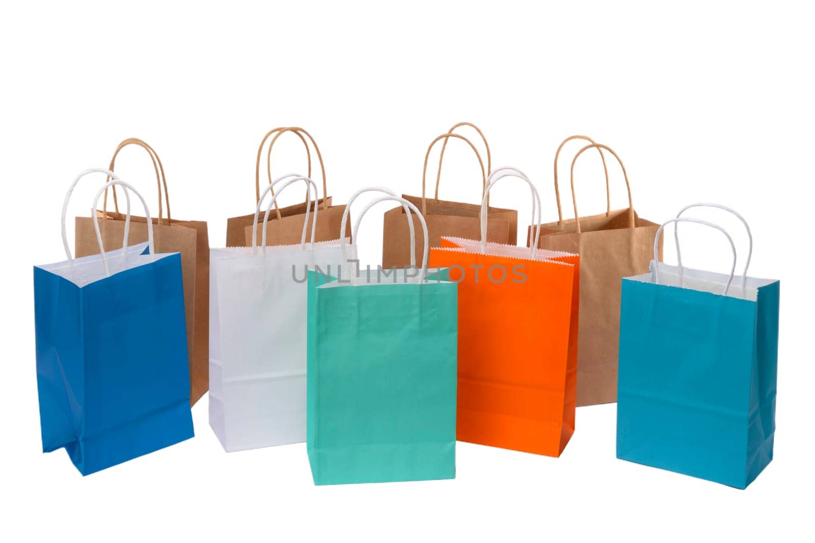 Variety of colored paper shopping bags on white background. Empty area.