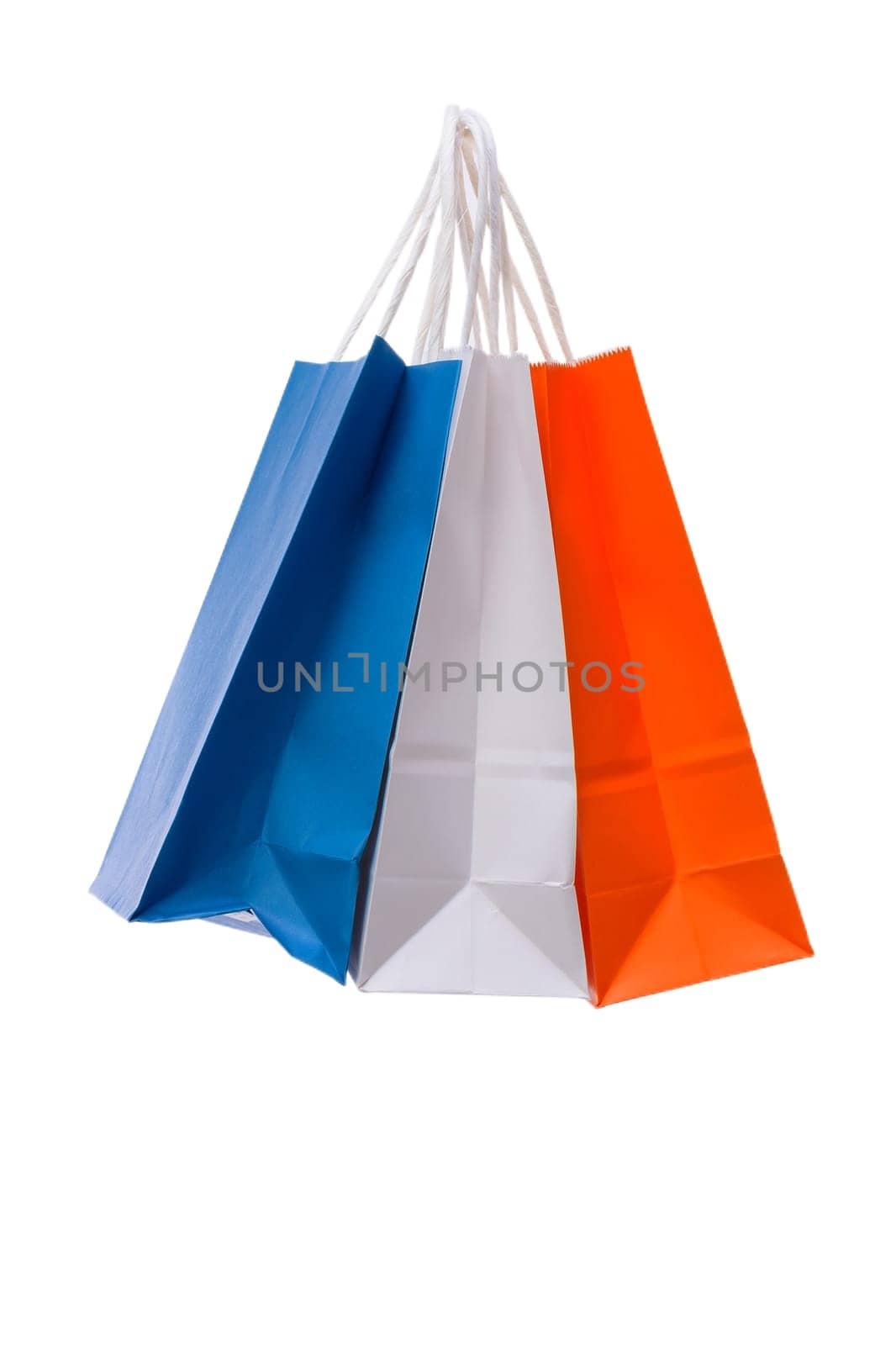 Variety of colored paper shopping bags on white background. Empty area.