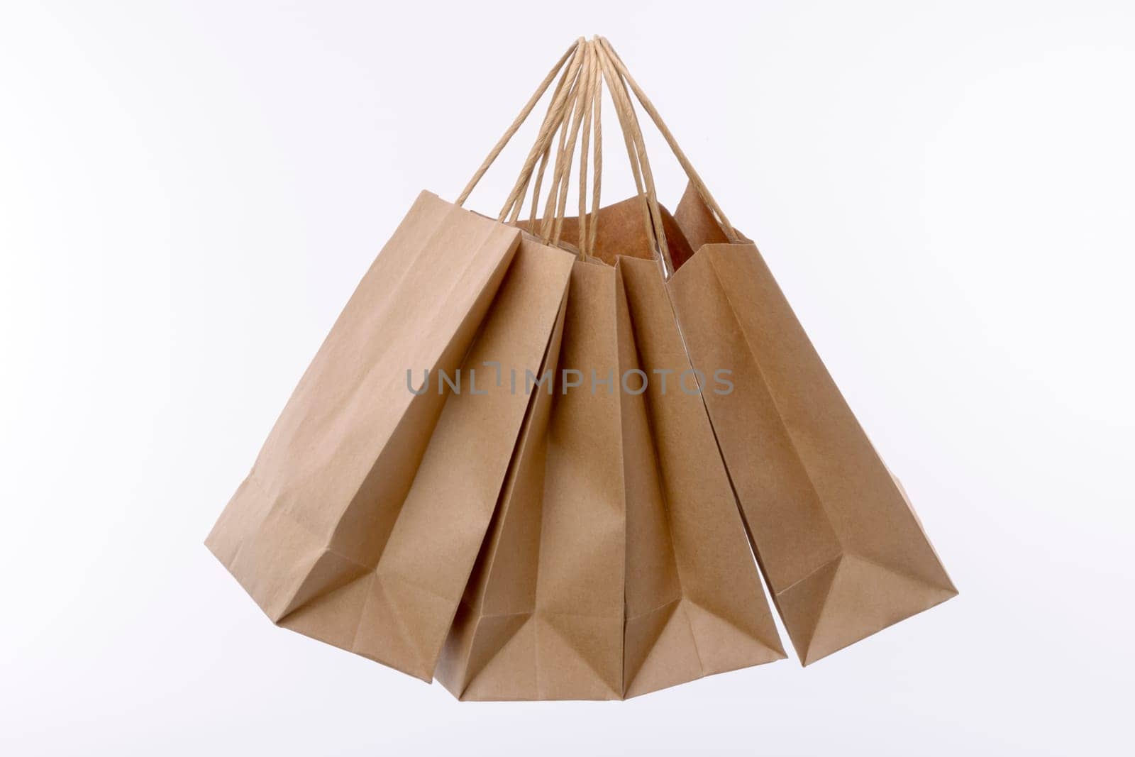 Brown paper shopping bags on white background. Empty area.