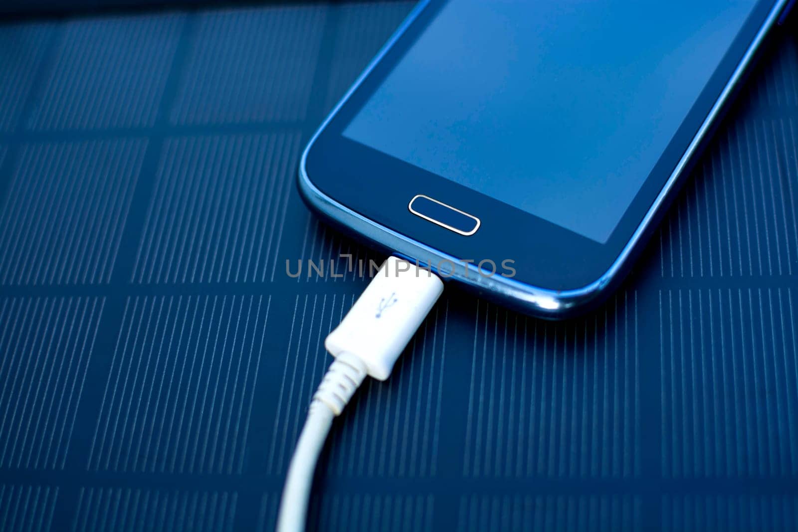 Use of renewable energy - Mobile Phone Chargers on grass in nature with Sun