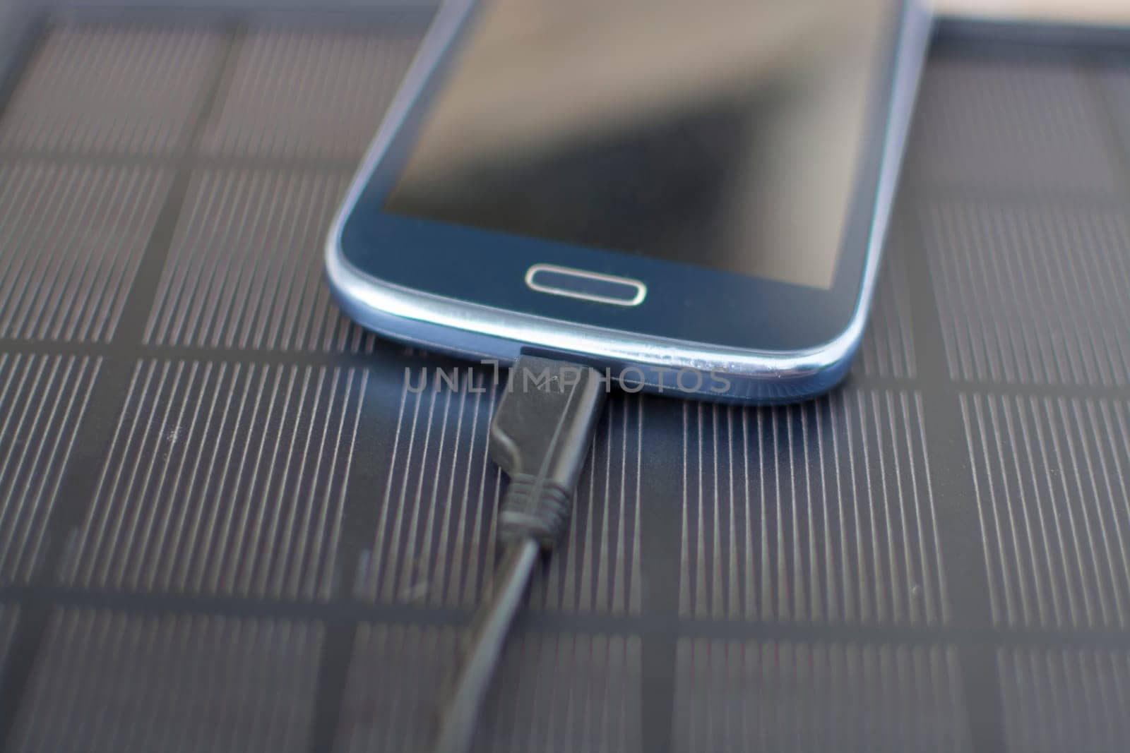 Use of renewable energy - Mobile Phone Chargers on grass in nature with Sun
