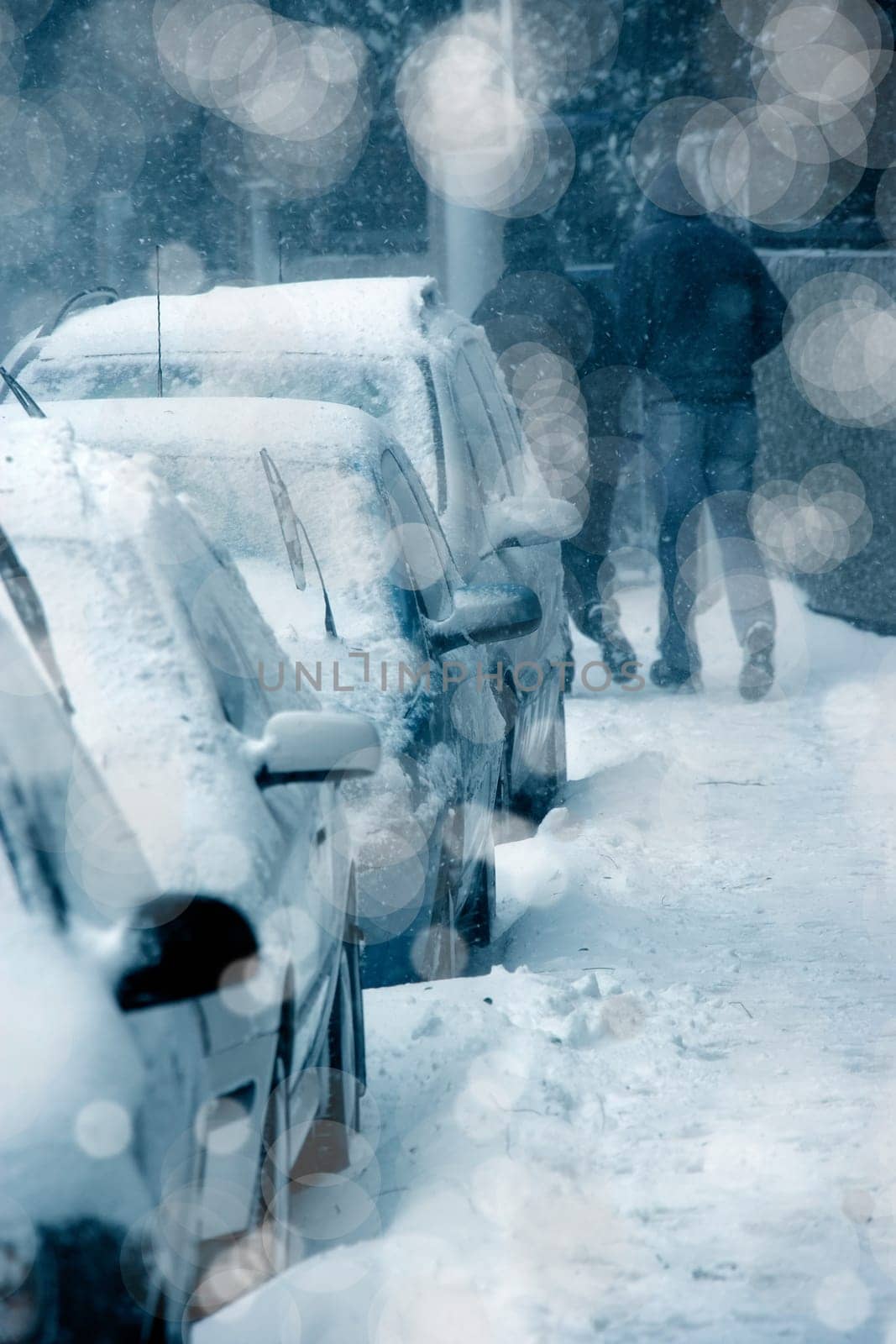 people walking on city street under snowing