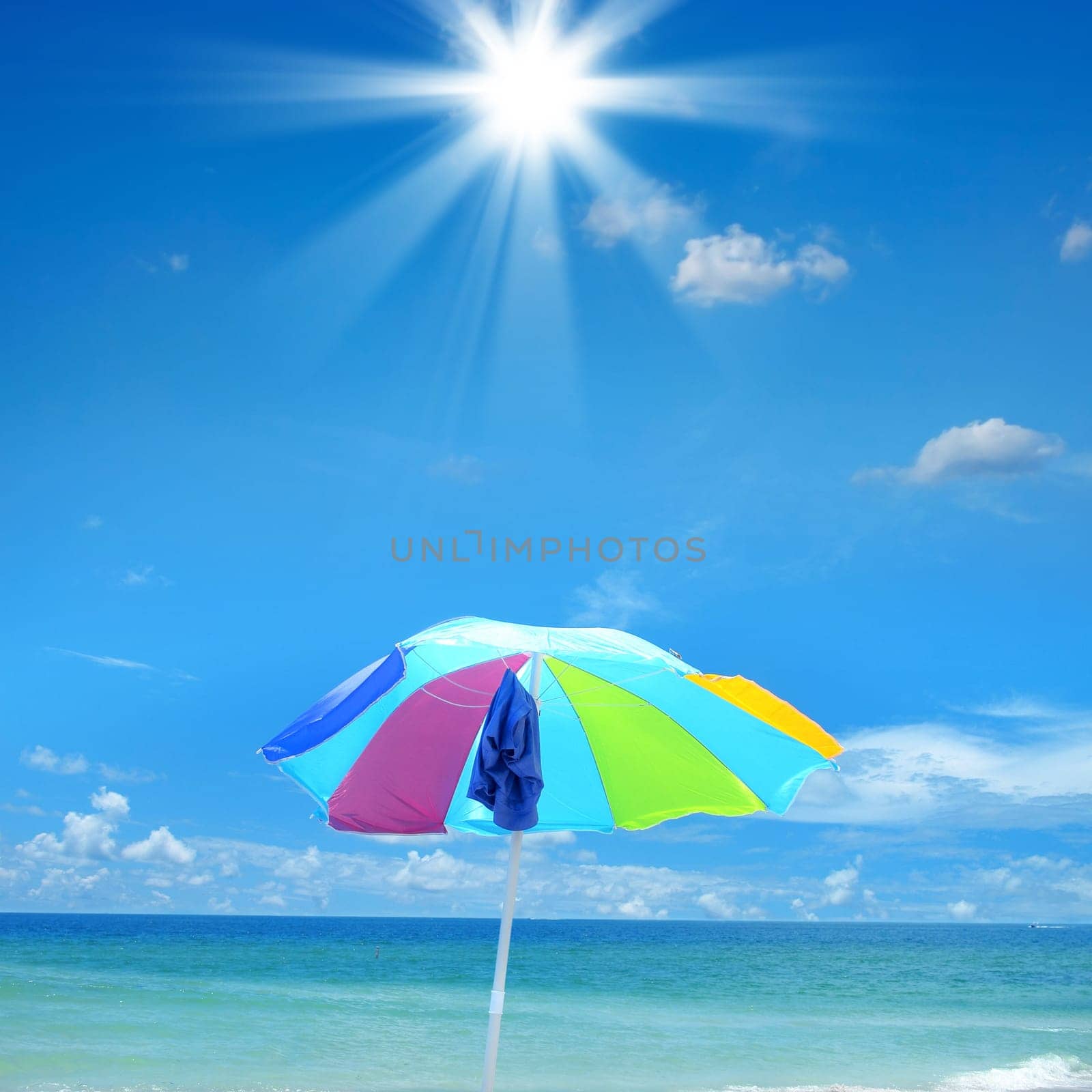 close up shot of beach umbrella over sunny sky