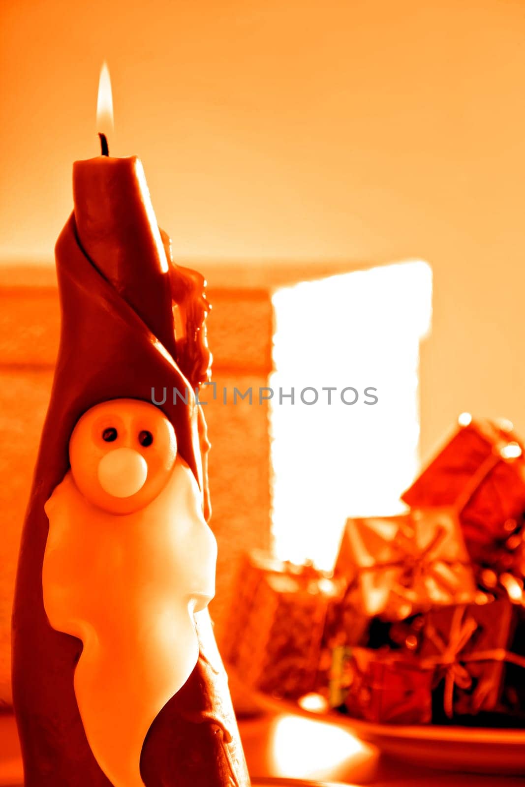 an image of Santa Clause candle and gift boxes in Christmas time