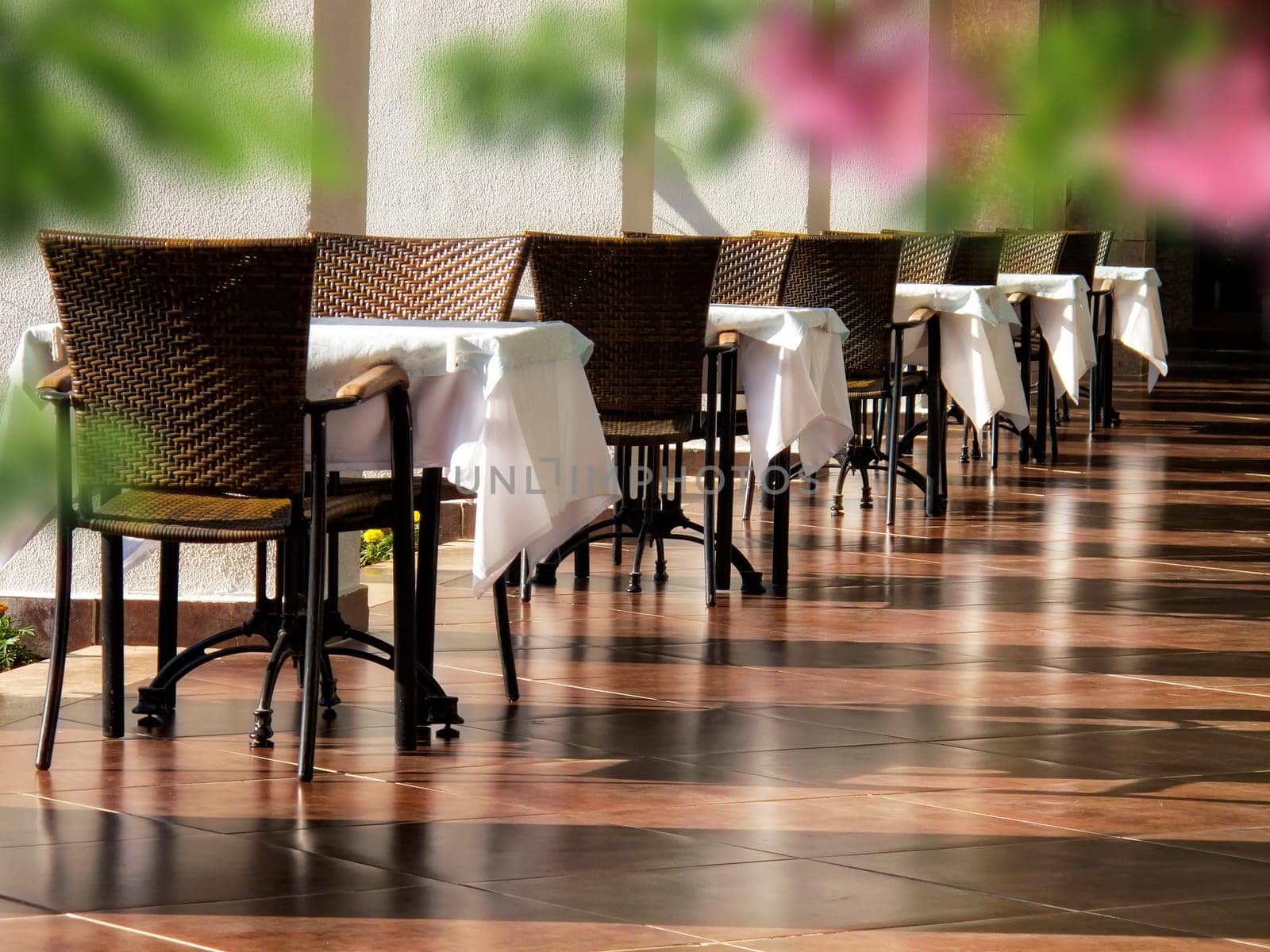 close up shot of outdoor empty restaurant table and chairs.