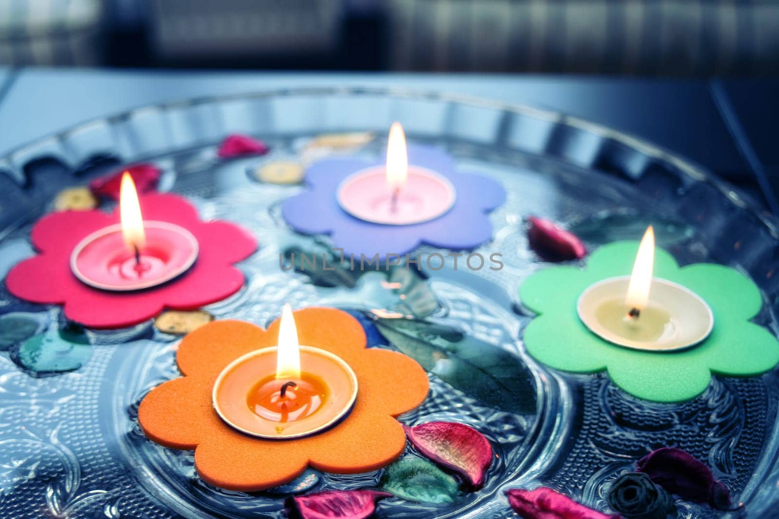 close up shot of floating candles in glass bowl.