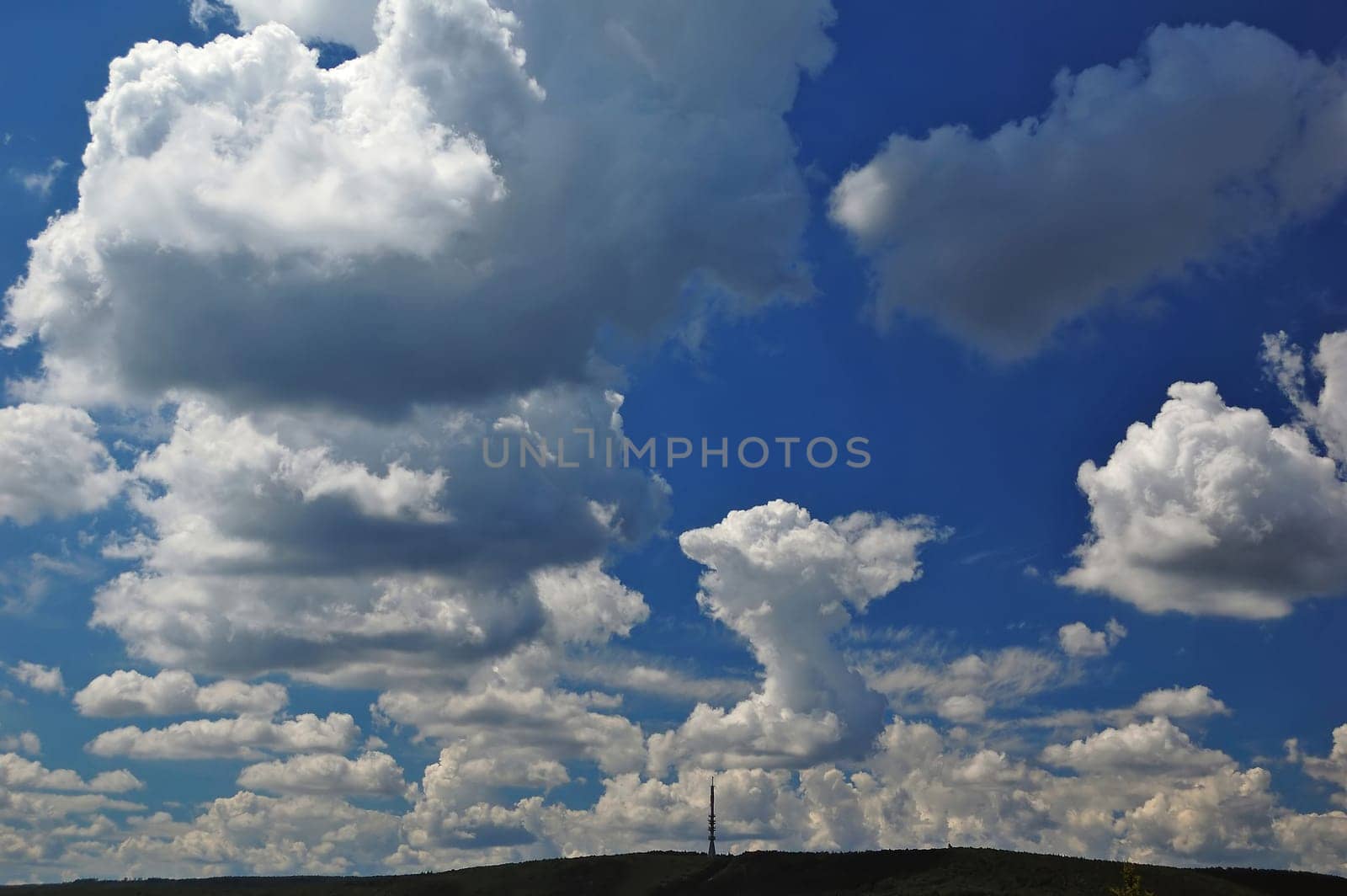 Hill with communication tower and clouds