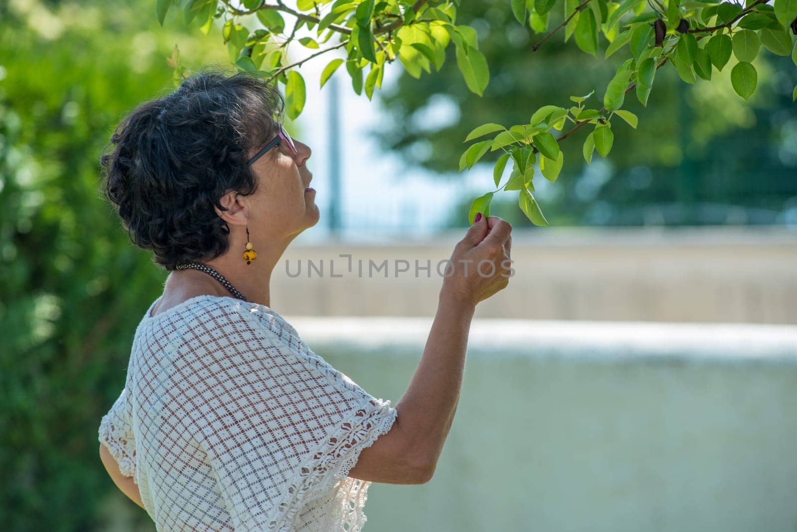 a portrait of a beautiful senior woman in the garden