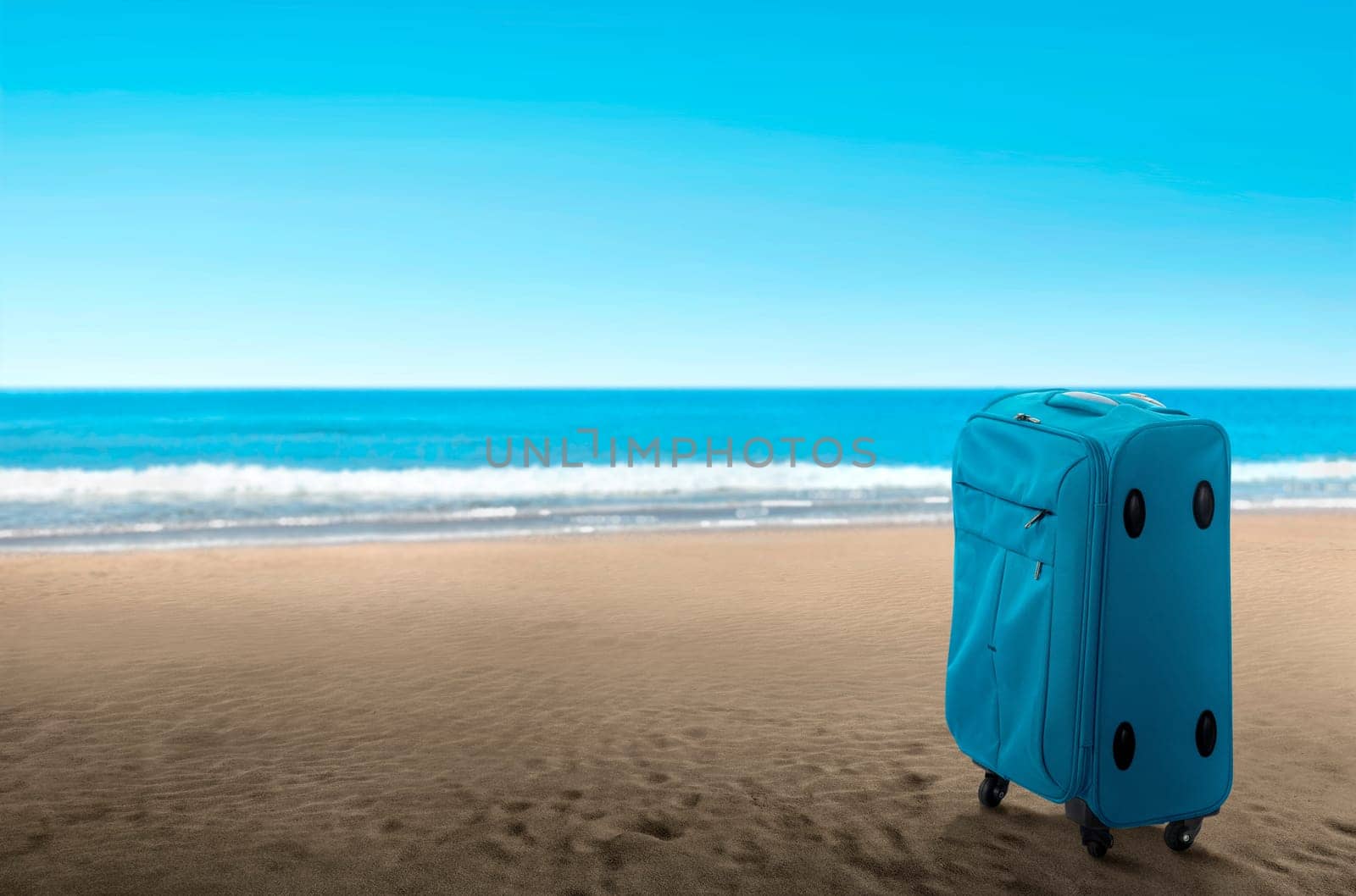 Blue suitcase on the beach. Summer travel concept