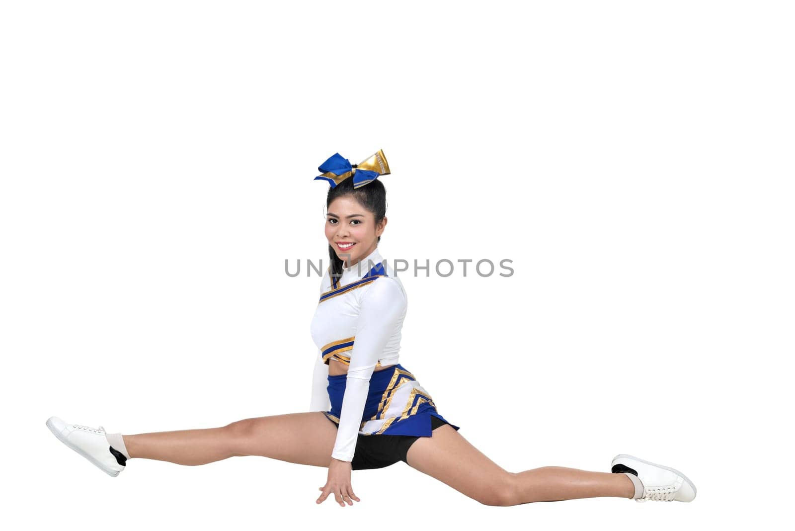 Beautiful asian cheerleader doing splits isolated over white background
