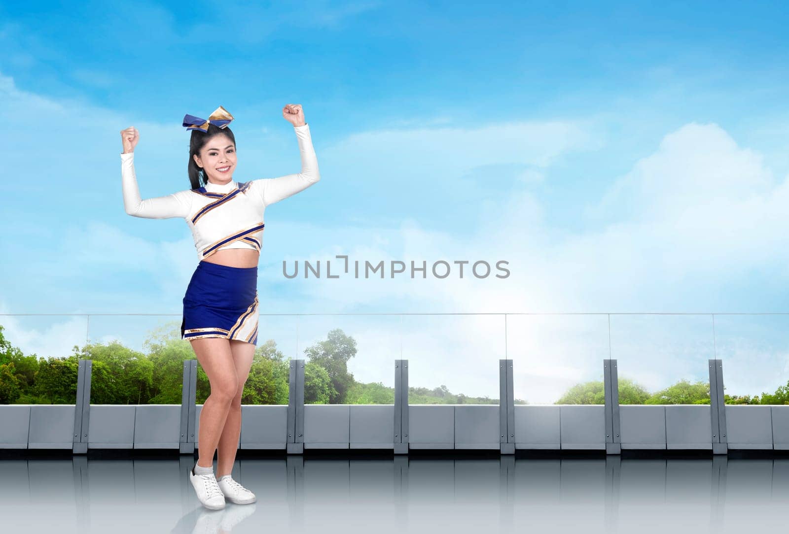 Cute asian cheerleader in action in the building