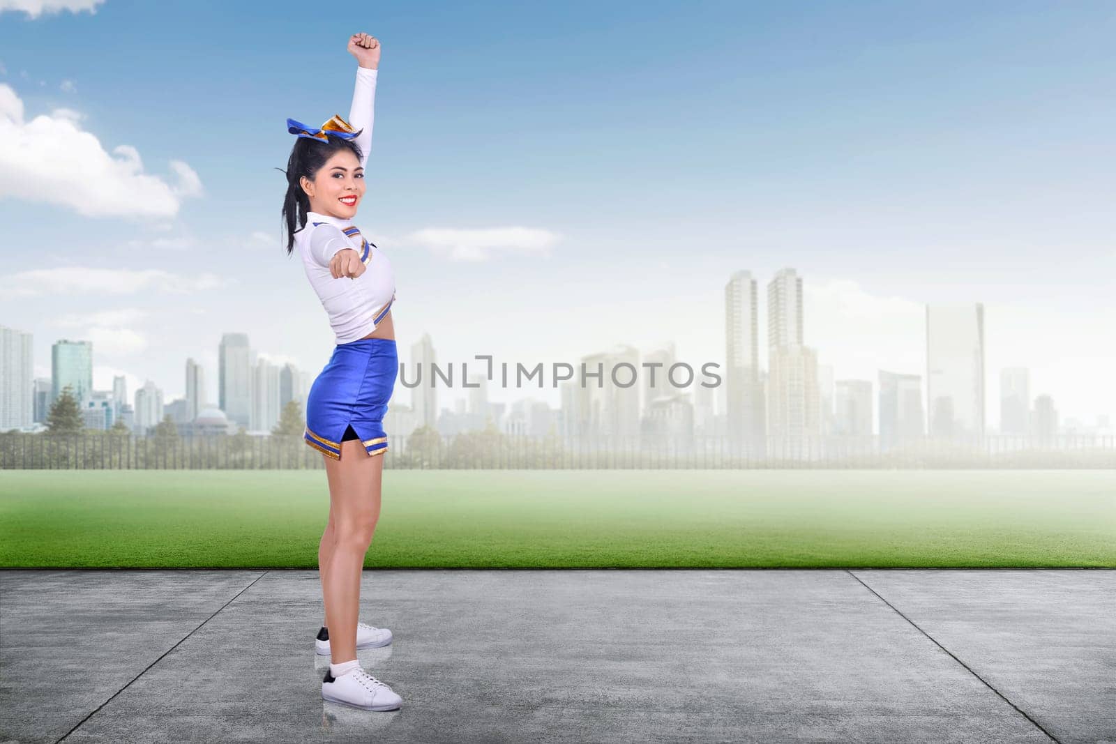 Young asian cheerleader performing at outdoor