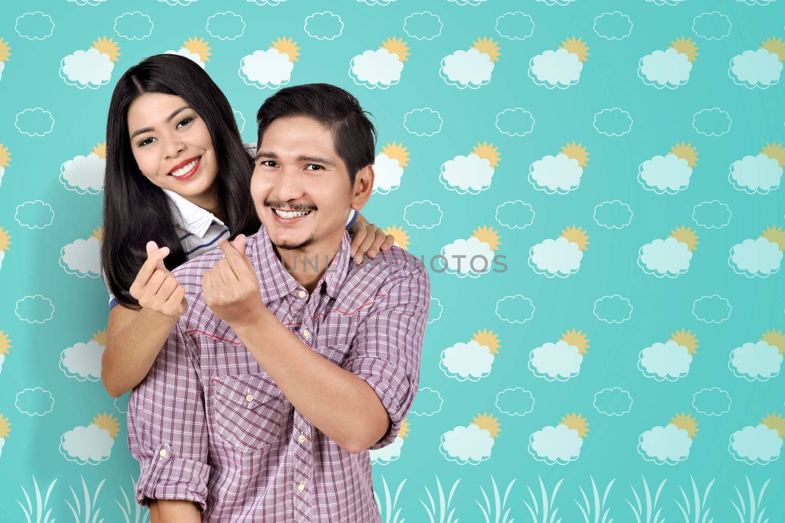 Romantic asian couple showing money sign over summer background
