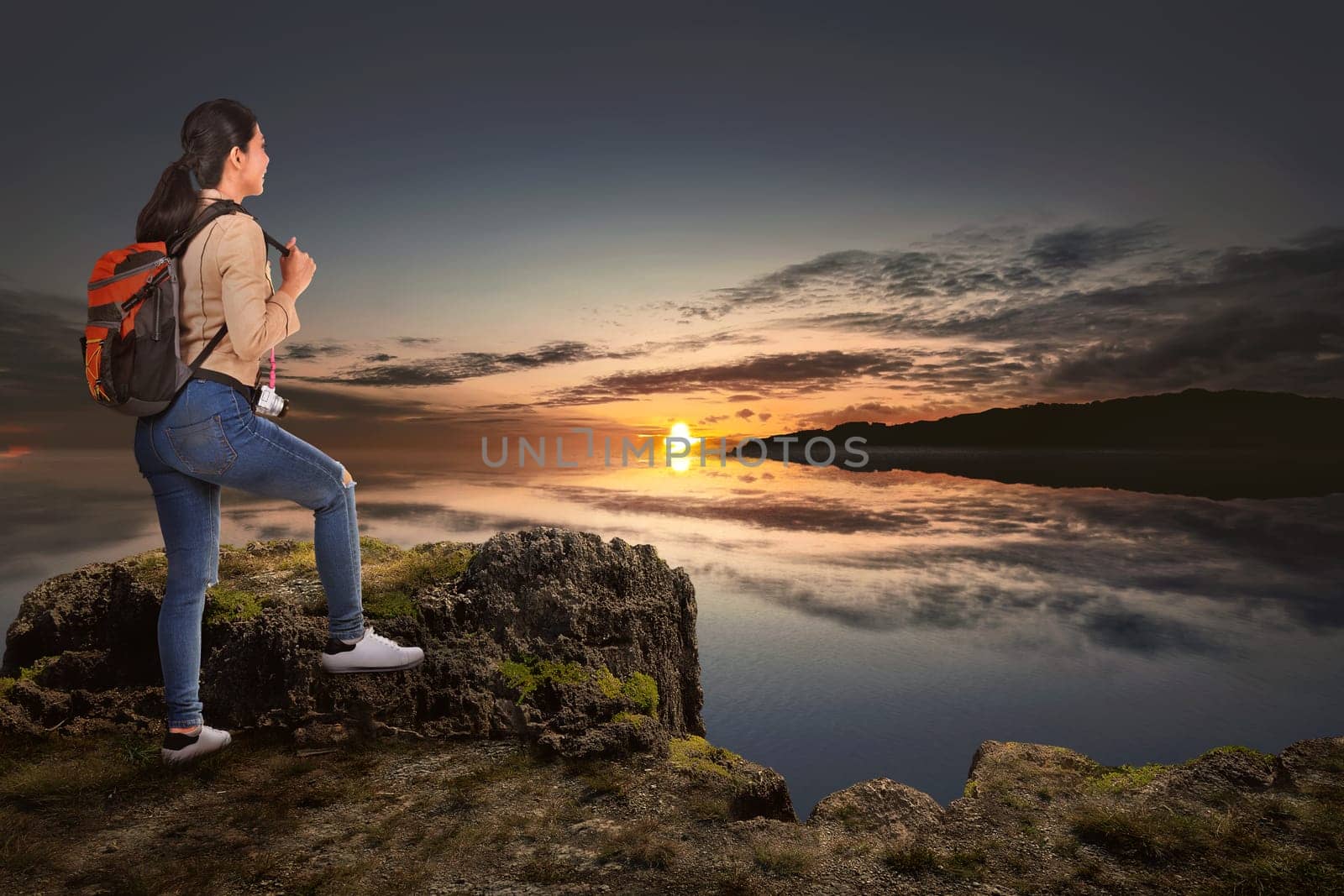 Young asian traveler woman standing and looking at panorama view from mountain peak