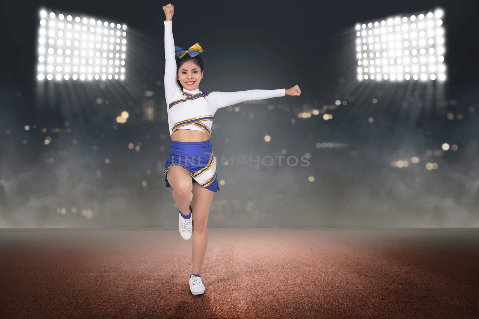 Young asian cheerleader in blue and white suit on the stadium