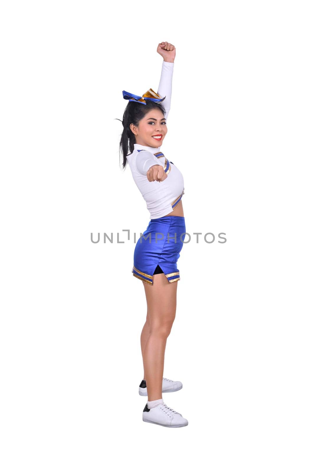 Beautiful asian cheerleader in action isolated over white background