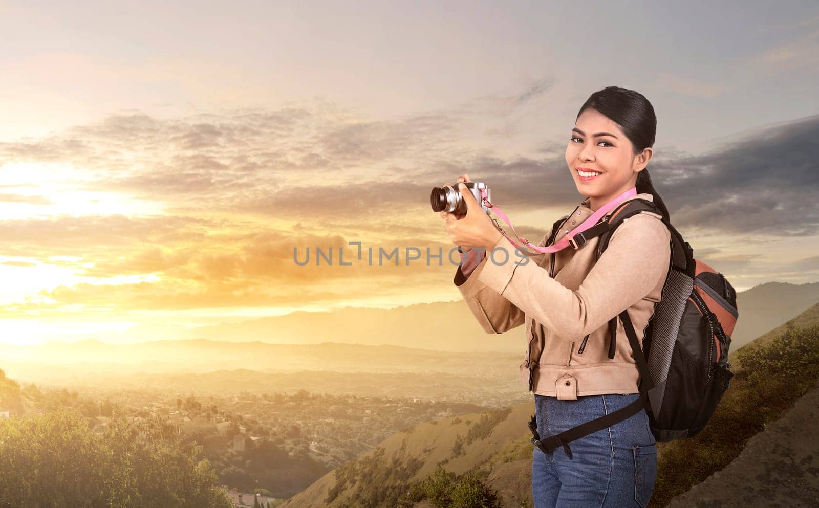 Beautiful asian photographer woman with camera and backpack at mountain