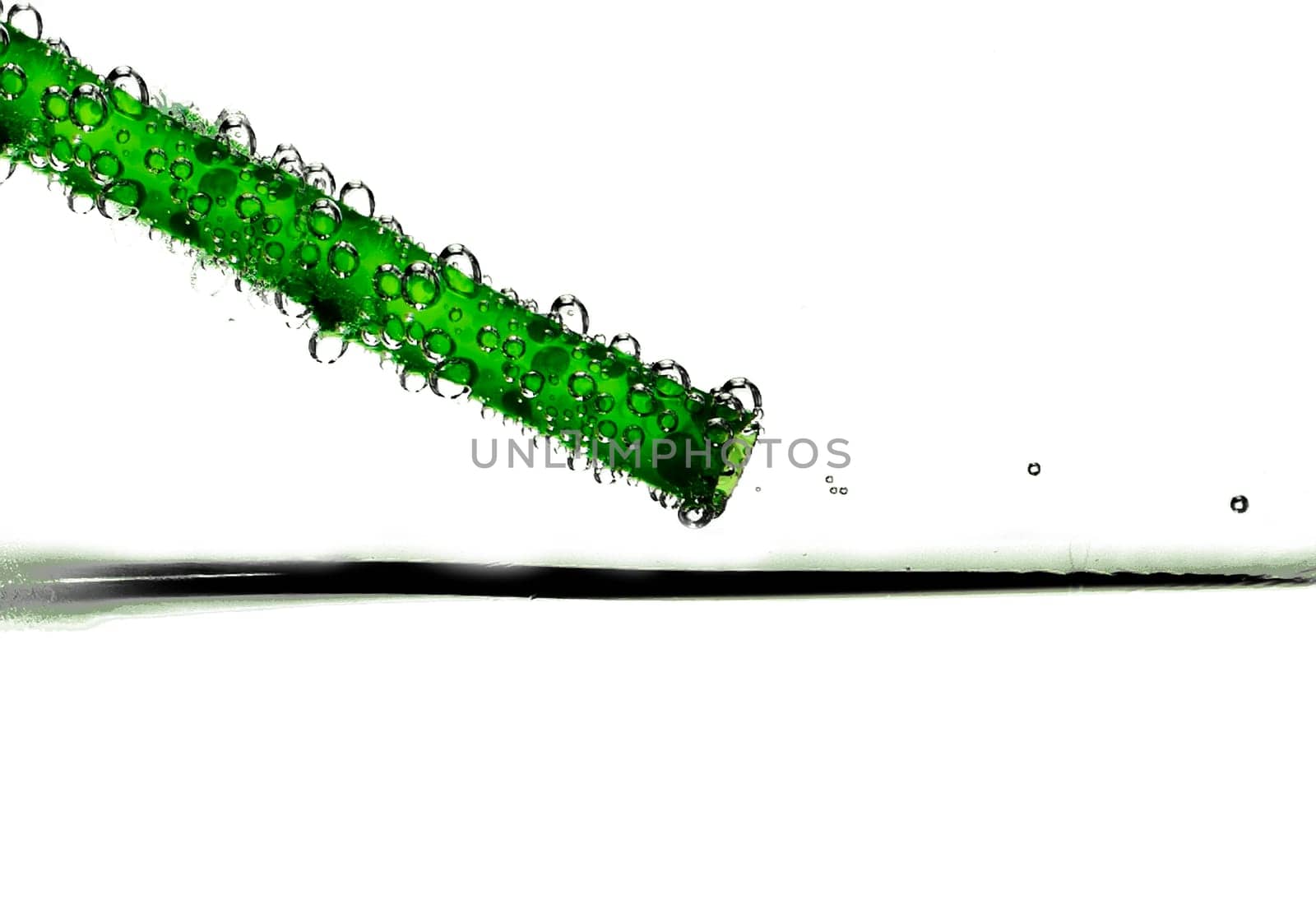 Abstract image showing a green drinking straw with bubbles