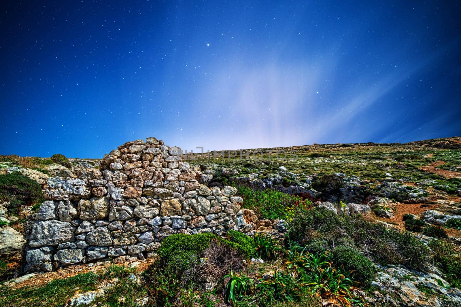 Remains of a Punic wall at Ghajn Tuta Cave in Mellieha in Malta, shot by moonlight.