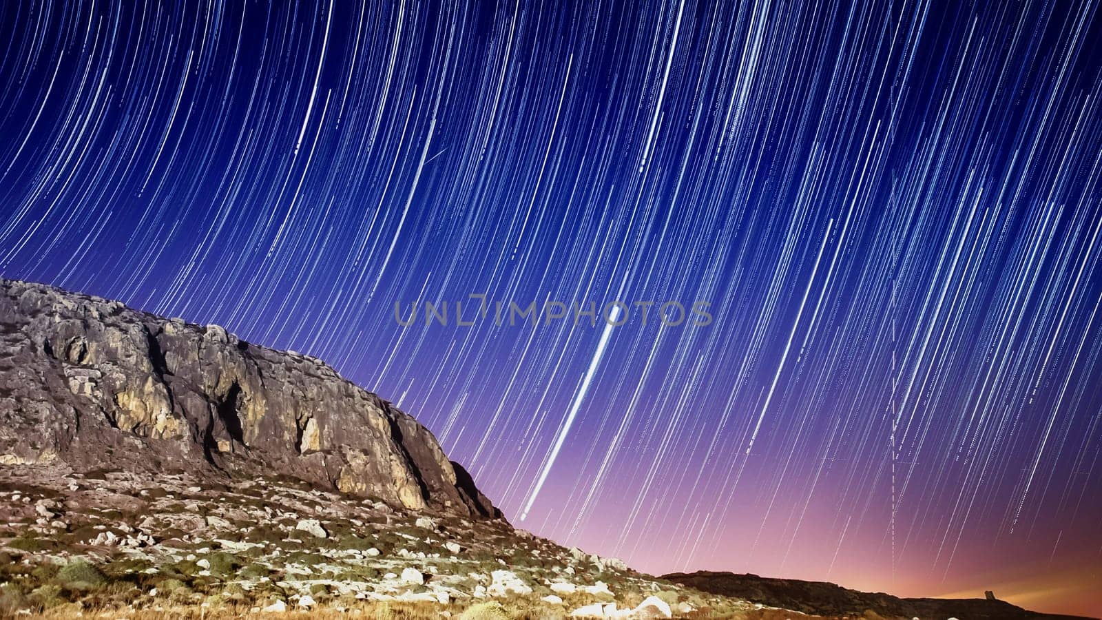 Extreme long exposure image showing star trails around the cliffs at Ghar Lapsi in Malta