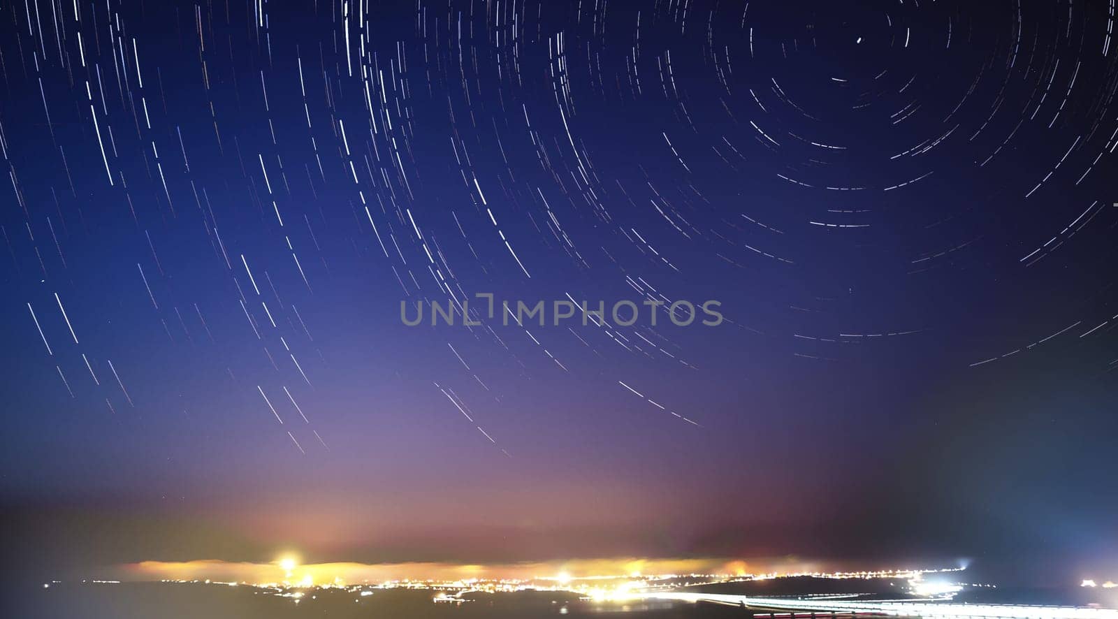 Extreme long exposure image showing star trails around the Polar Star or Polaris in the sky above Gozo
